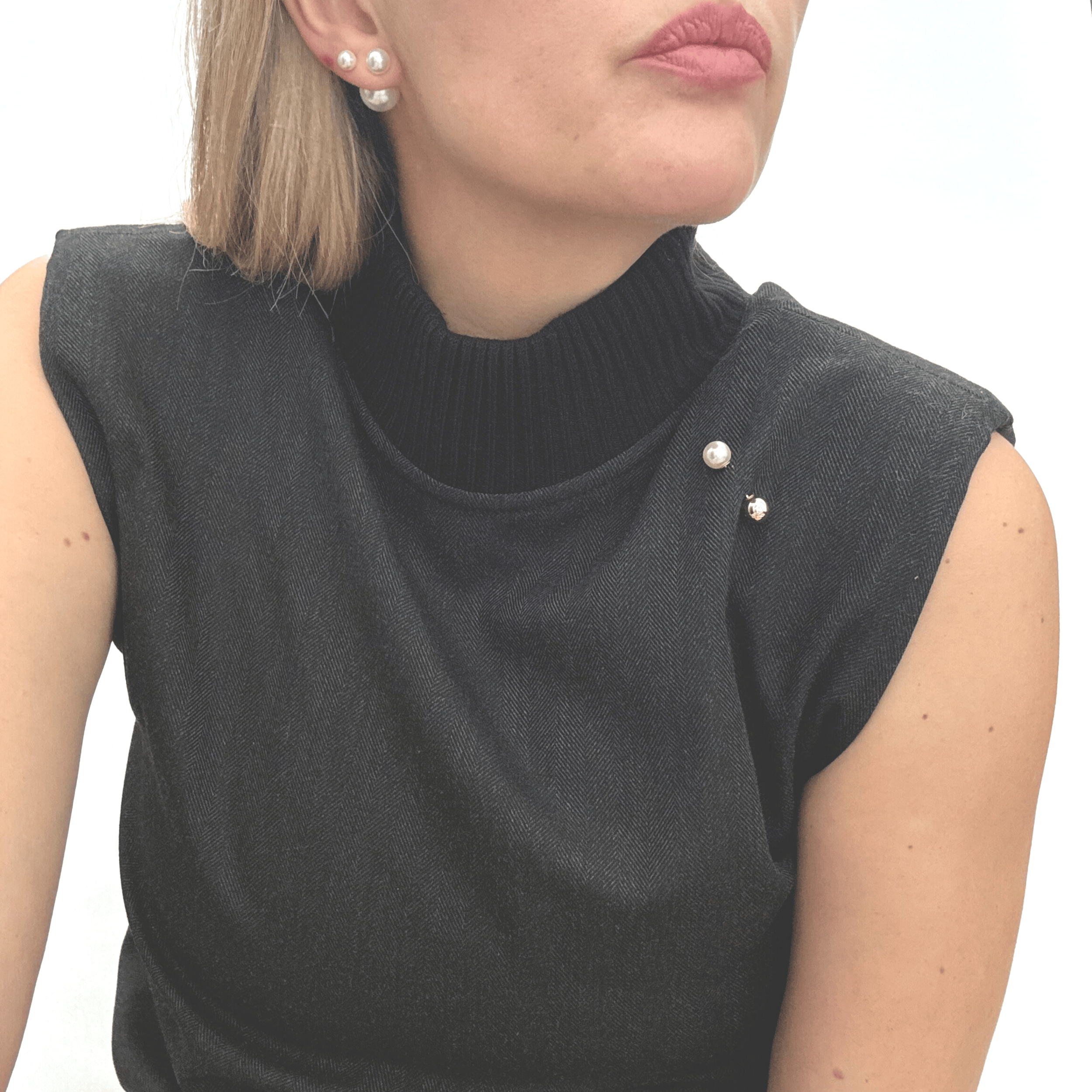 Double sided pearl pin styled on sleek black tank.