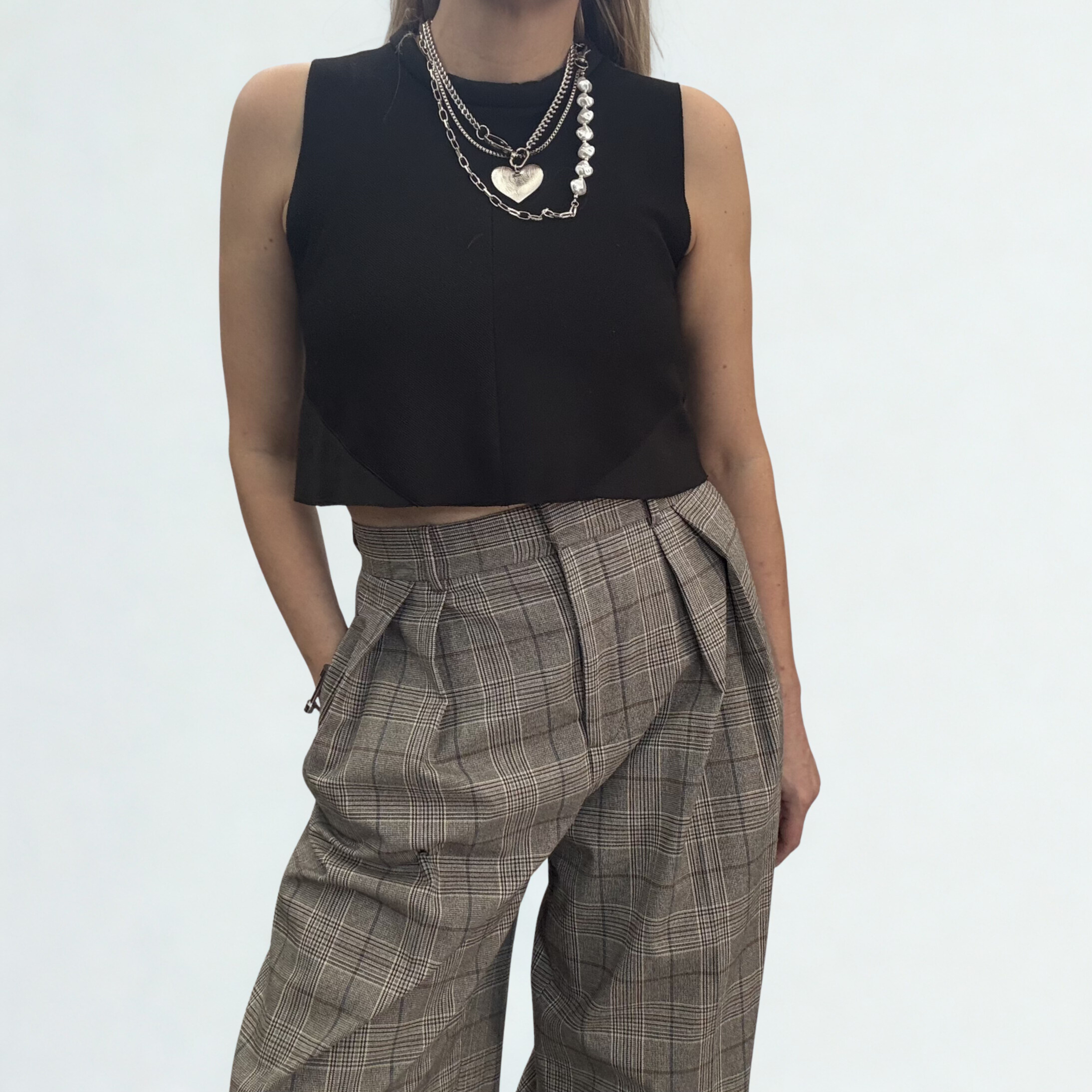 Trouser chain which consists of two layered chains: a substantial, classic curb link and a delicate faux pearl chain, styled as a necklace.