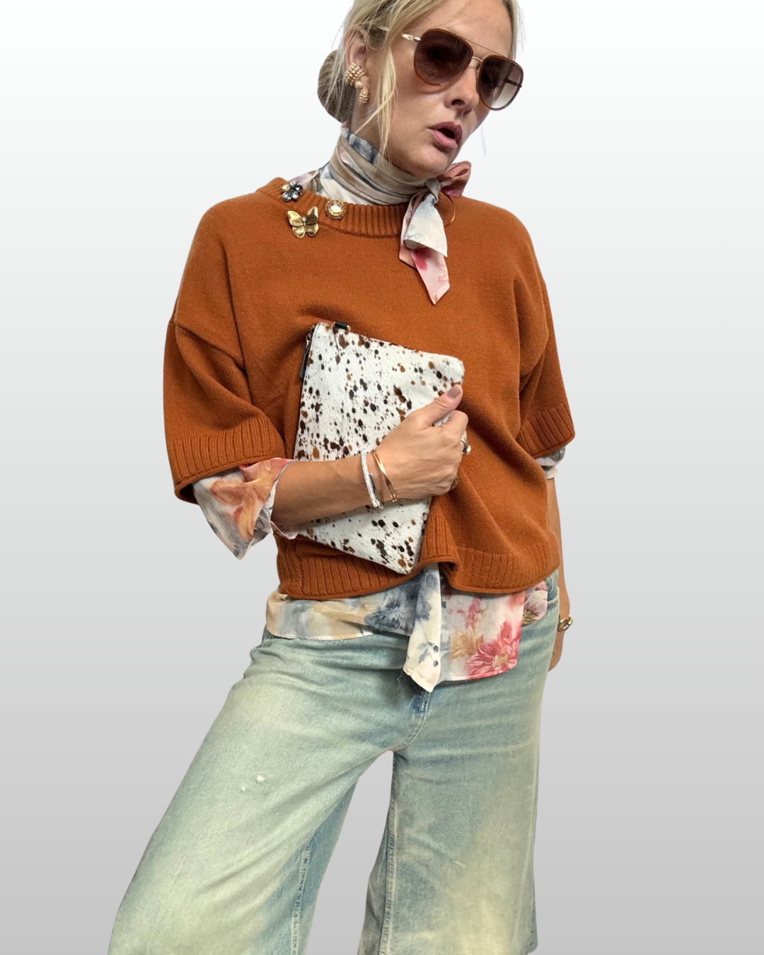 Cluster Trio brooch styling on a warm-toned sweater with an asymmetrical necktie blouse.