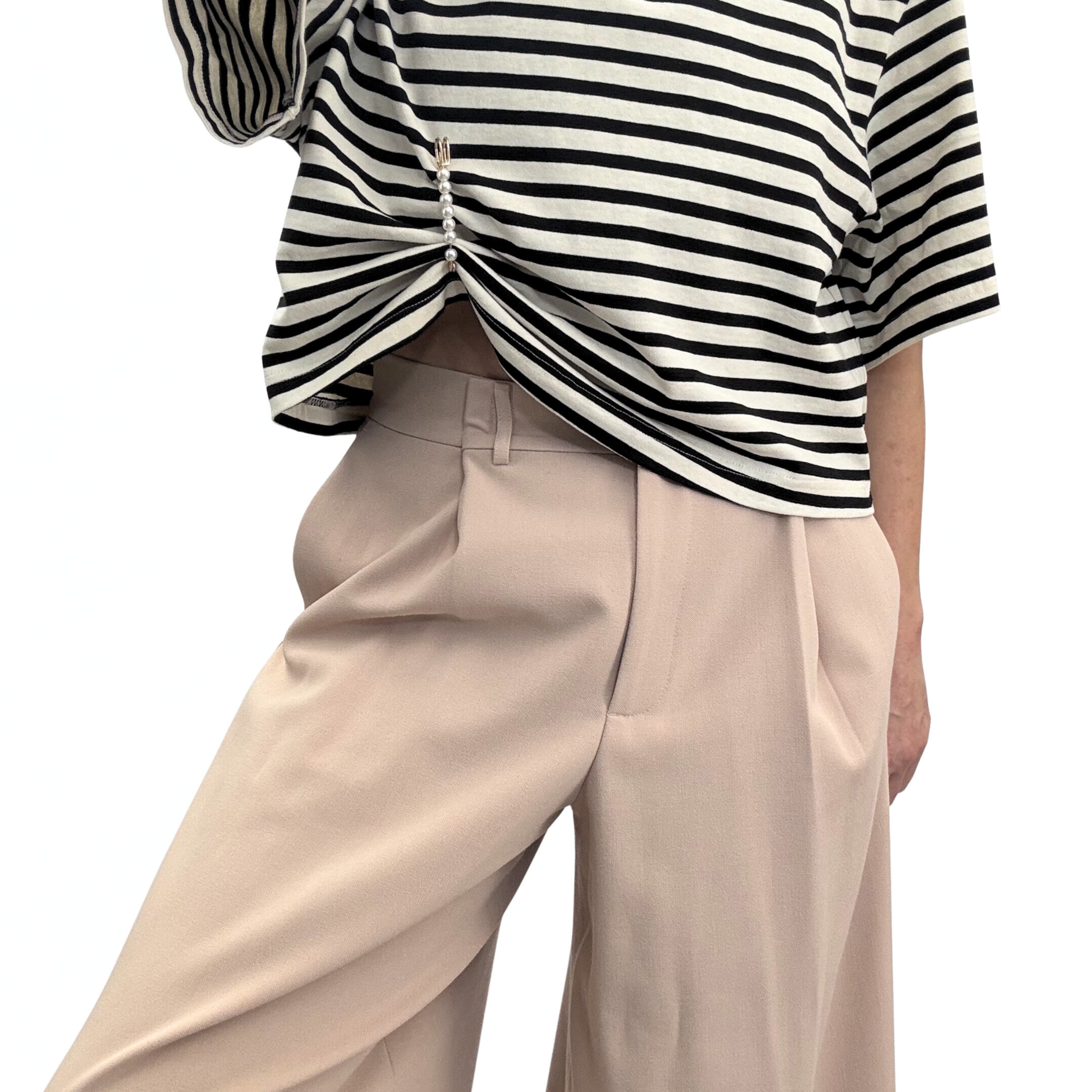 Gold toned safety pin, featuring a row of five high-lustre faux pearls used to pinch fabric on the hem of a striped tee giving a cropped effect.