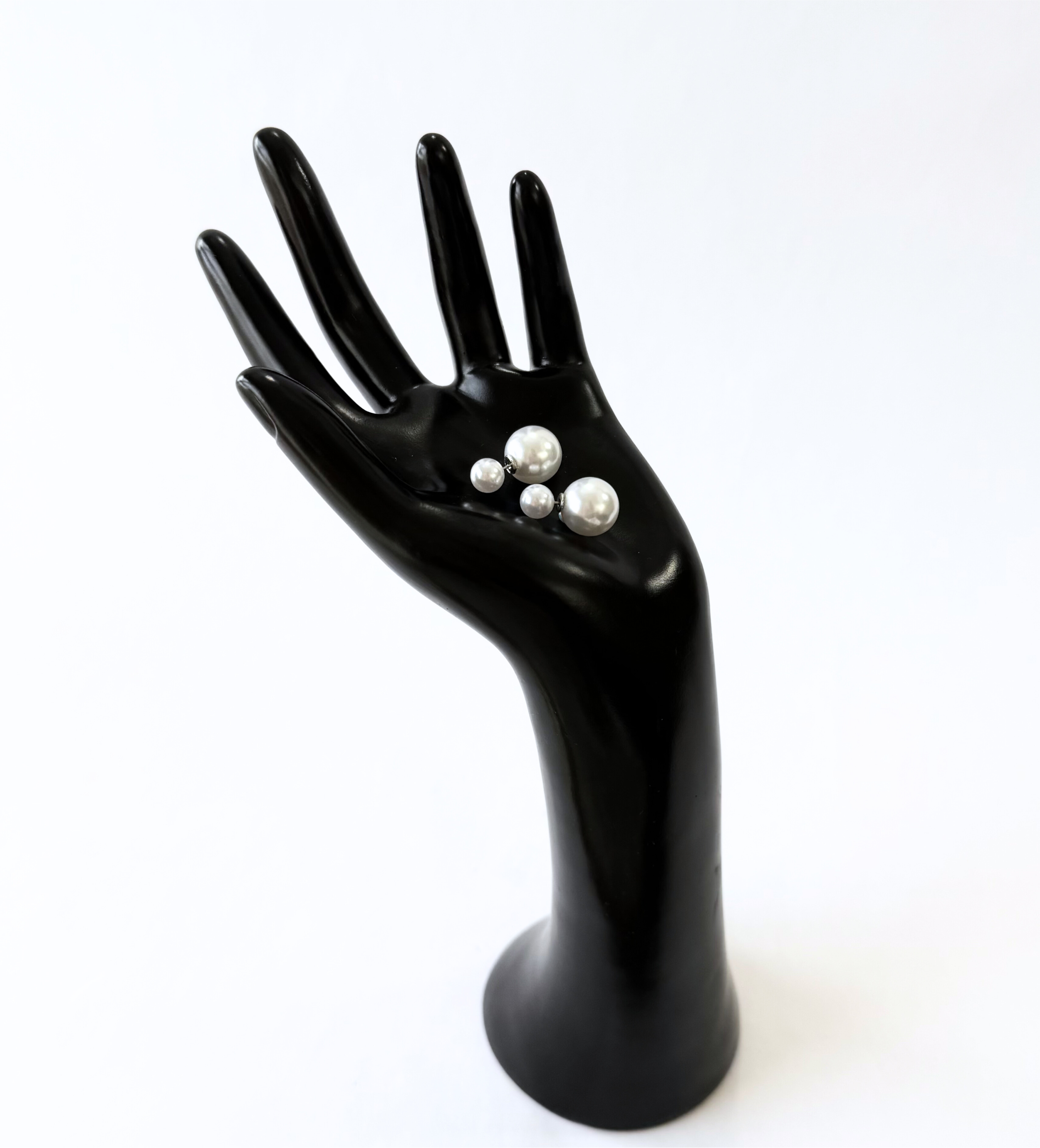 A sophisticated two-piece earring design featuring a high-luster faux pearl stud in the front and a larger pearl jacket that secures behind the earlobe.