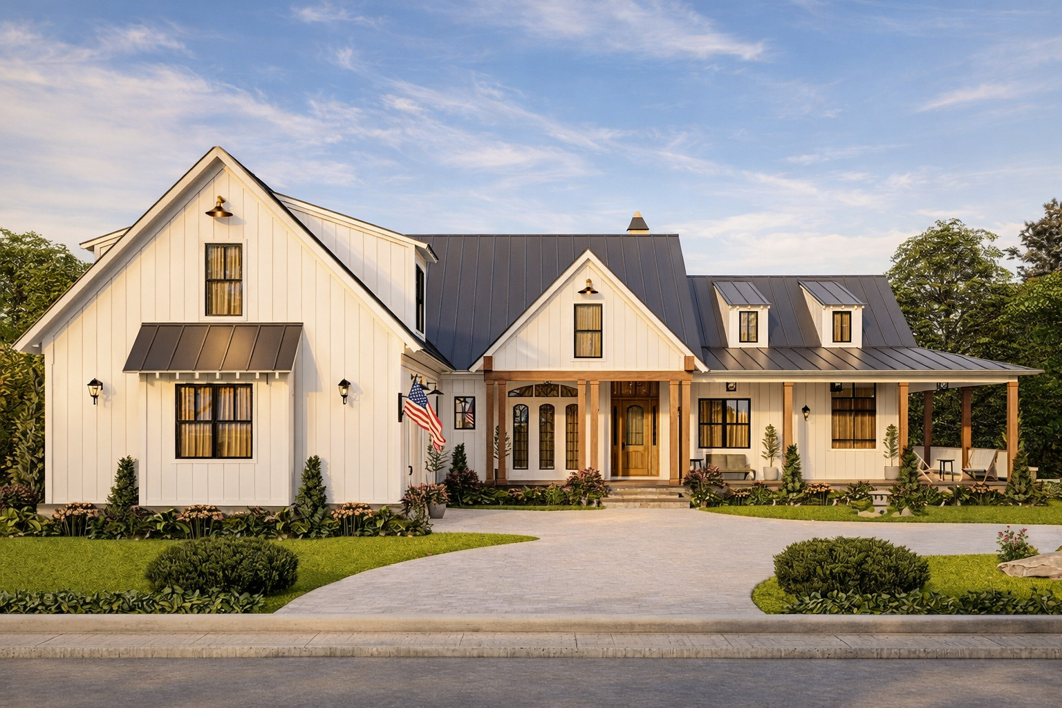 A large white house with a black roof, multiple windows, and a front porch, illuminated at sunset with a wet driveway and manicured lawn.