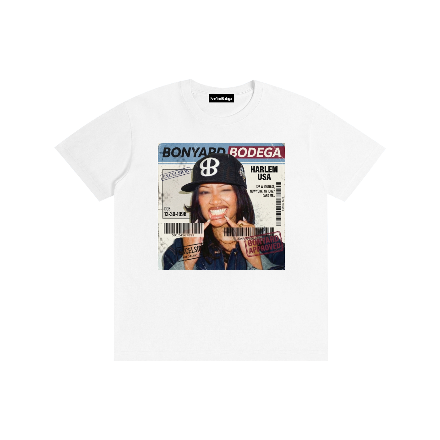 White T-shirt with a graphic design resembling a subway or ID card featuring a woman making a playful face with her tongue out, holding her own chin, wearing a dark cap with a white logo. The design includes text such as "BON YARD BODEGA," "HARLEM US