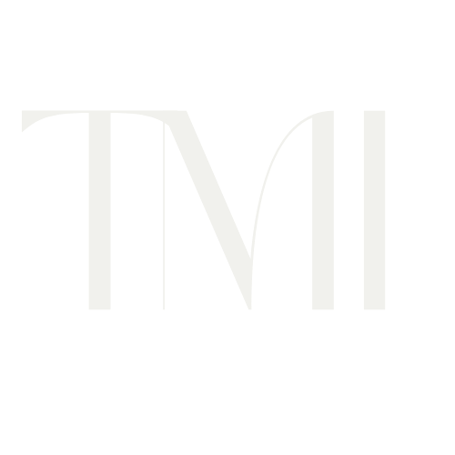 Close-up of the text 'TMI' in a stylized, modern font on a black background.