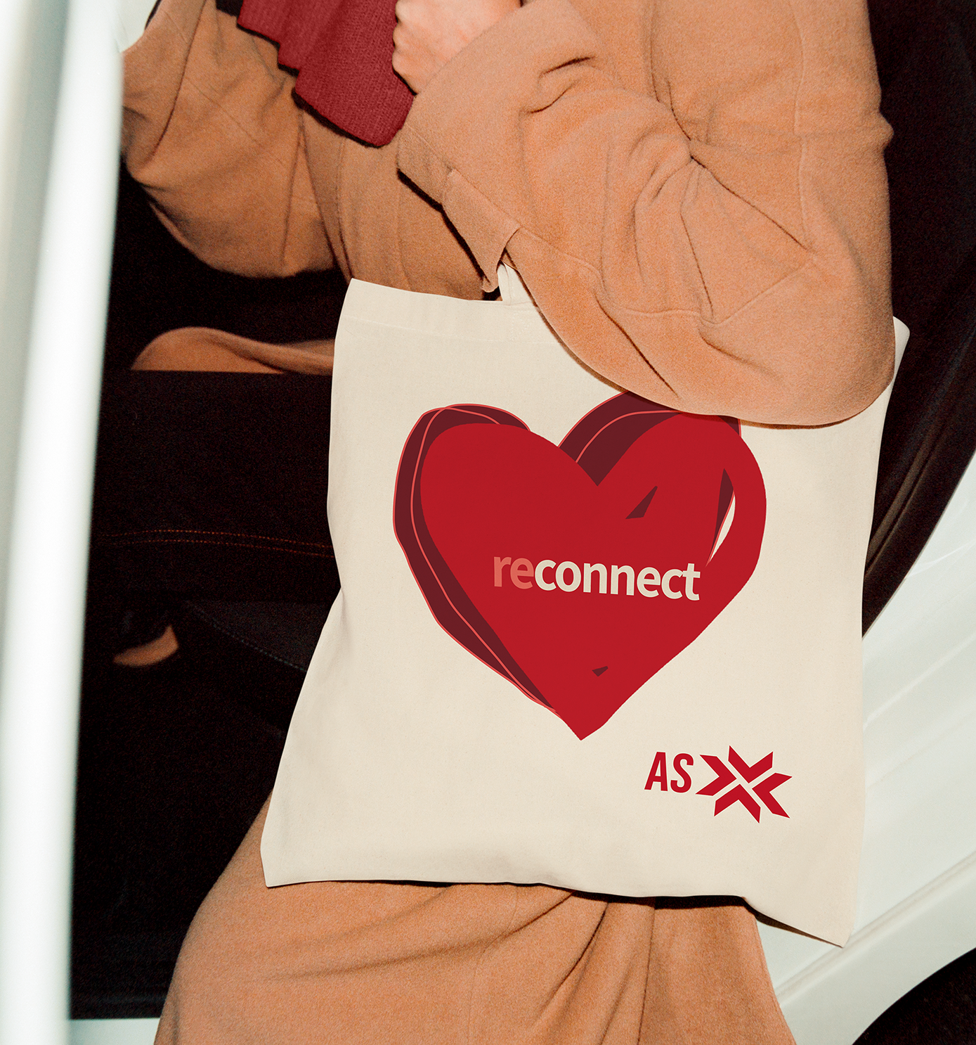 A woman holding a tote bag with mixed use property, Atlantic Station, logo and branding design.