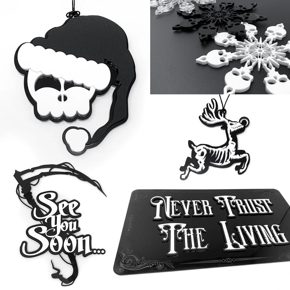Will Pigg Collection of black and white Christmas-themed cutouts including a skull wearing a Santa hat, snowflake designs, a reindeer, a message saying "See You Soon...," and a sign that reads "Never Trust the Living."