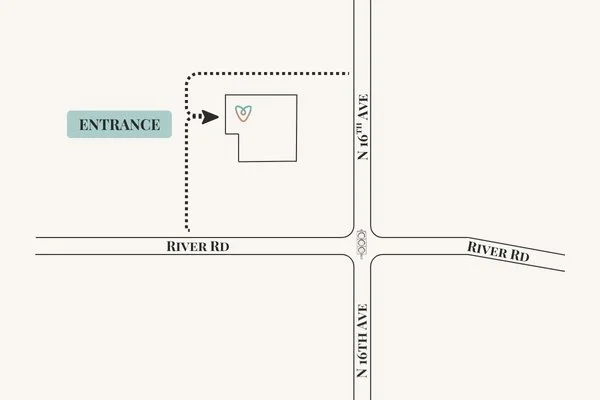Map showing an entrance to a property at the intersection of River Road and N 16th Ave, with a building and a small heart symbol nearby.