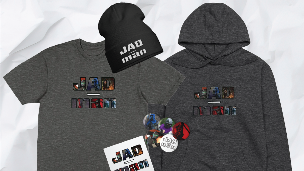 A collection of apparel and accessories including a gray T-shirt, a gray hoodie, a black beanie, and buttons, all featuring the word "JAD-man" with colorful and urban-themed designs.