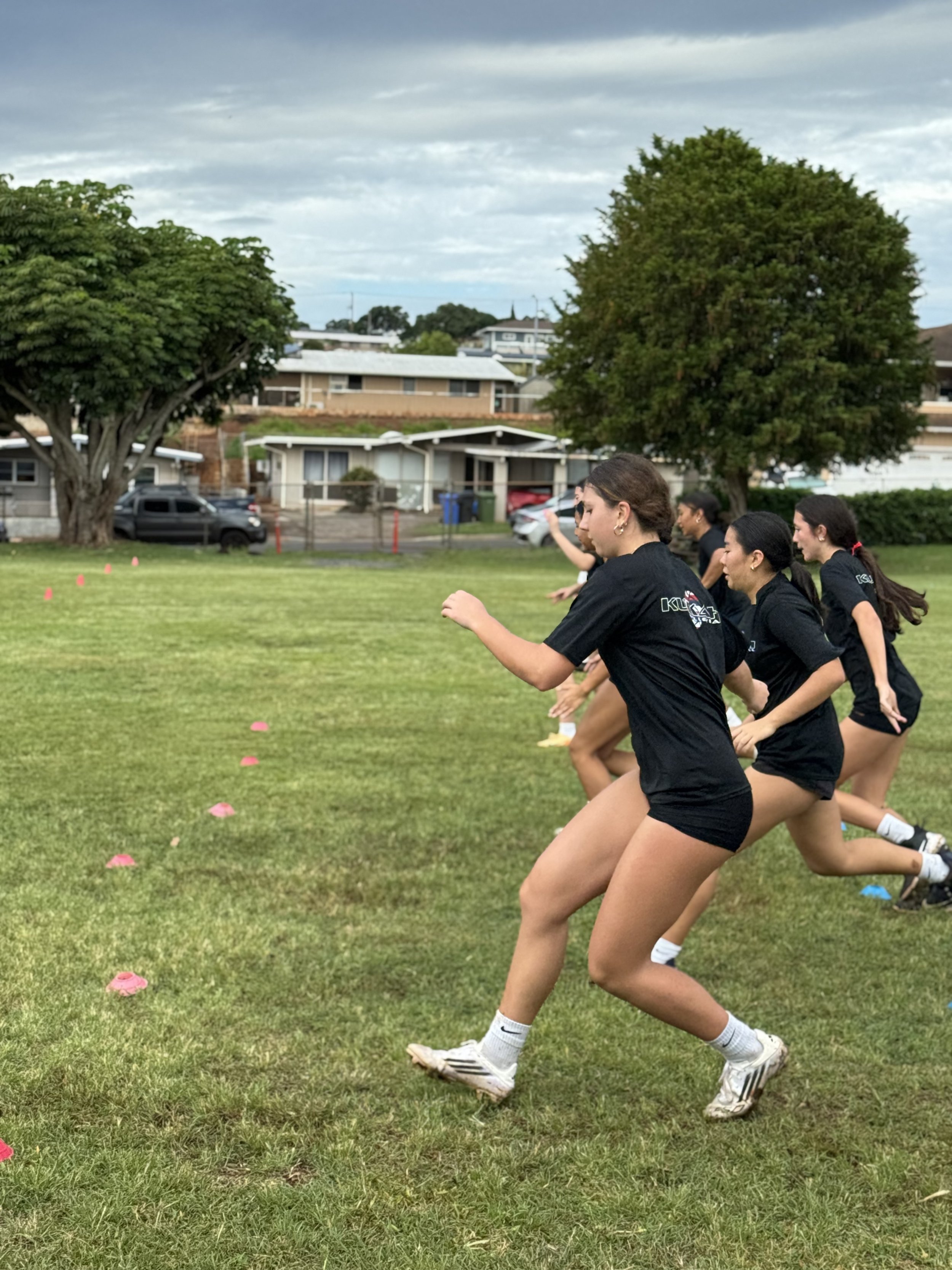 Athletes race to cone during agility session