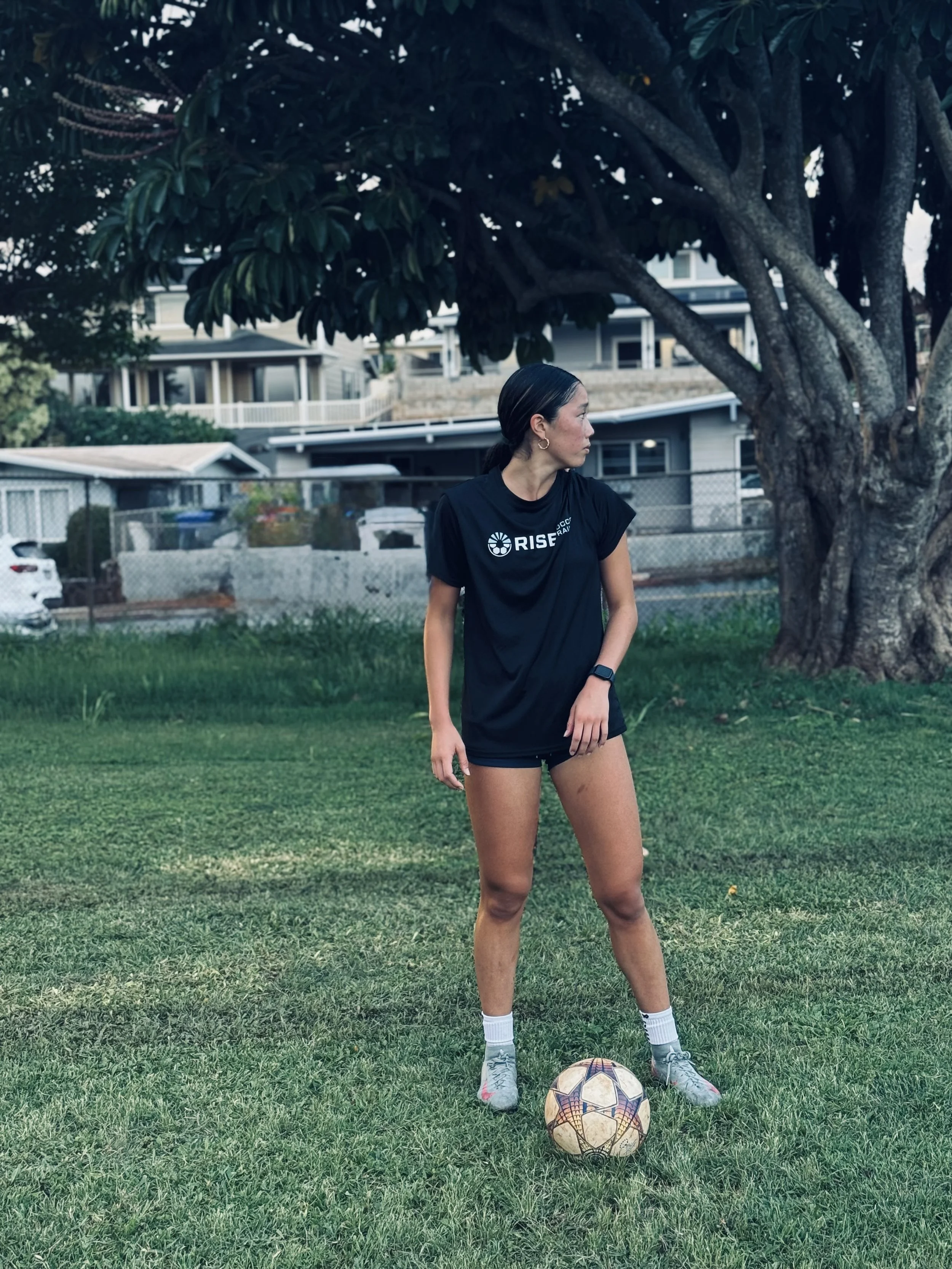College soccer player with ball at training