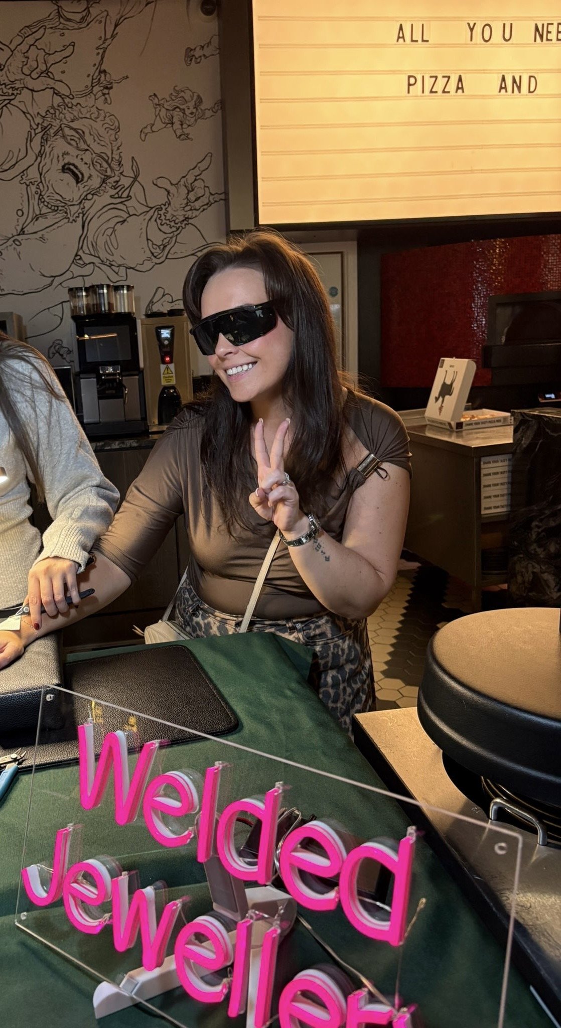 A woman getting permanent welded jewellery at a permanent jewellery pop up party.