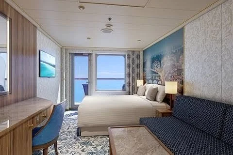 Ocean view room with a bed, sofa, and balcony