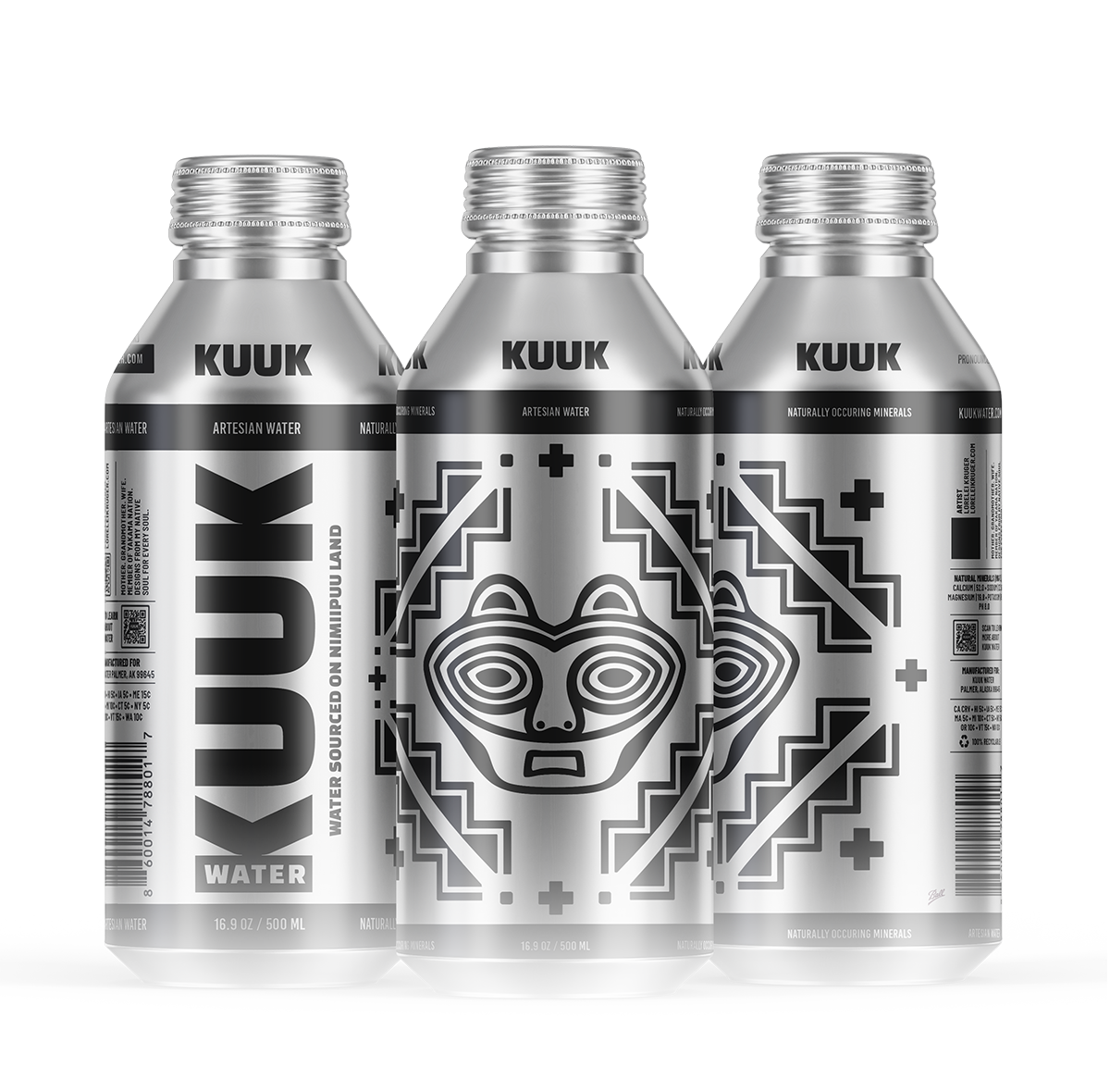 Three silver cans of KUUK artesian water with black and white abstract geometric labels, featuring stylized animal faces and tribal patterns.