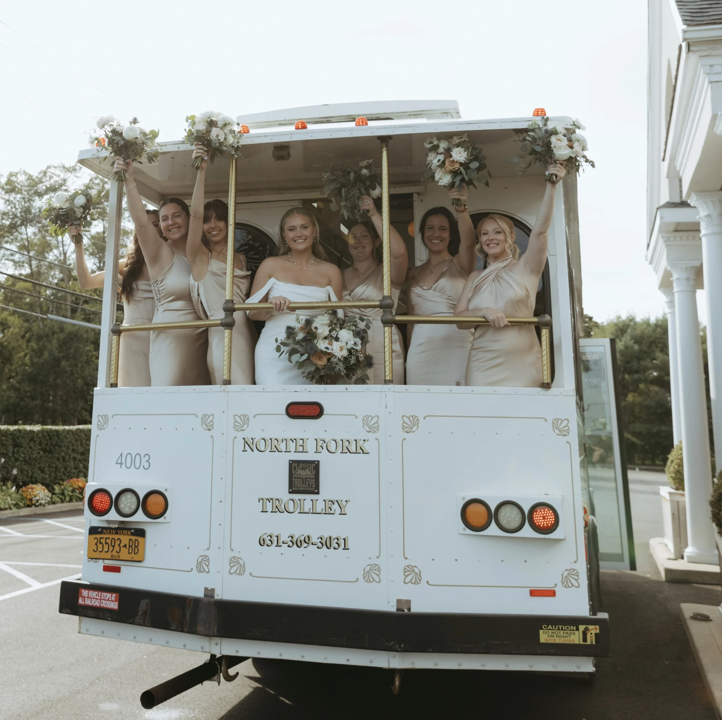Vintage trolley with wedding party at North Fork, Long Island venue.