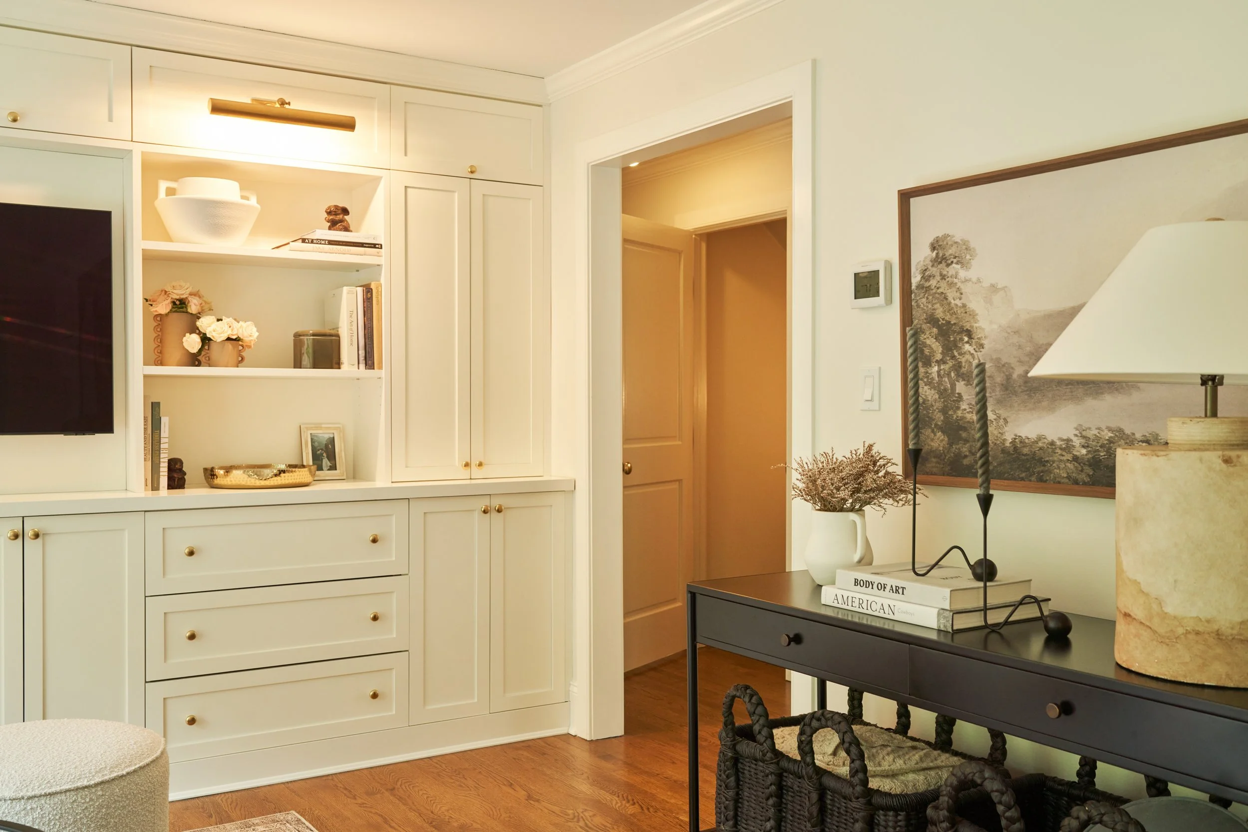 White built-in cabinetry with open shelving and display storage in a Long Island home