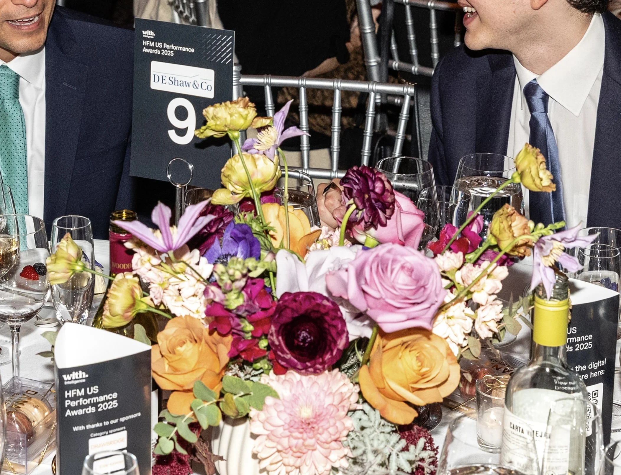 Vibrant mixed bouquet featuring pink, yellow, burgundy, and orange flowers at a New York City venue