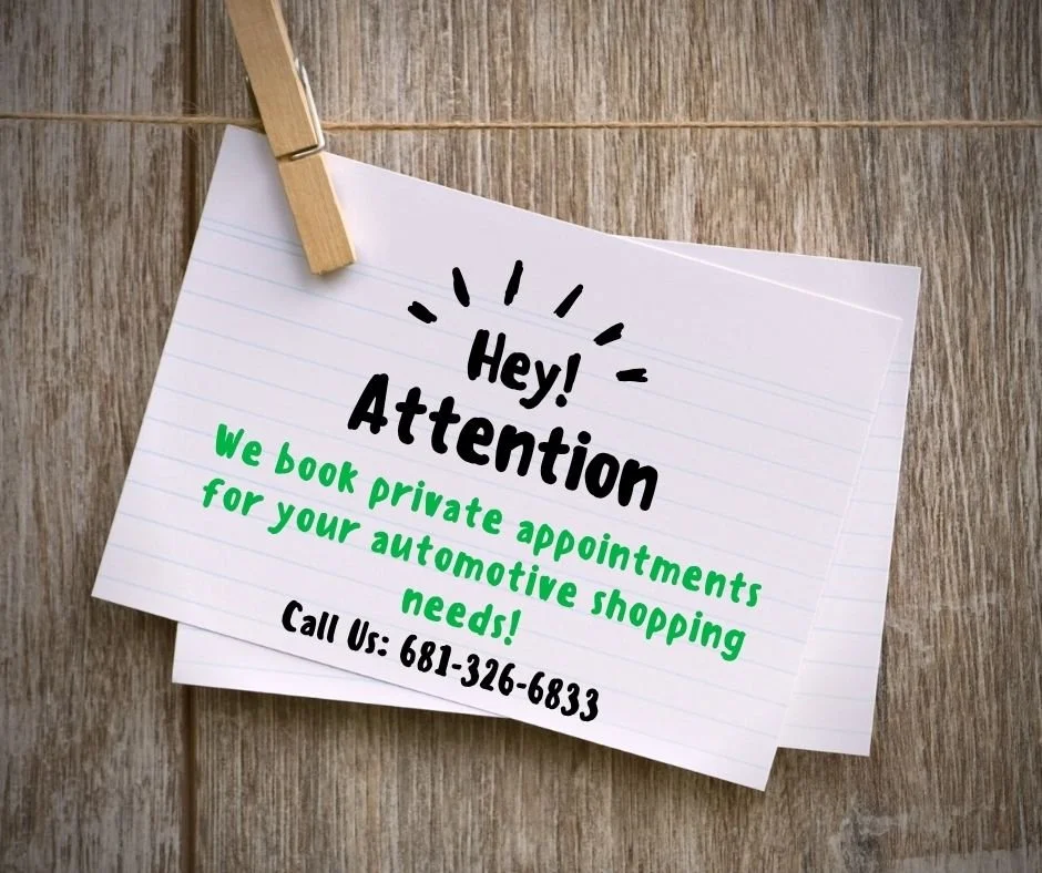 A note hanging on a string with a clothespin, advertising private appointments for automotive shopping needs, including a phone number.