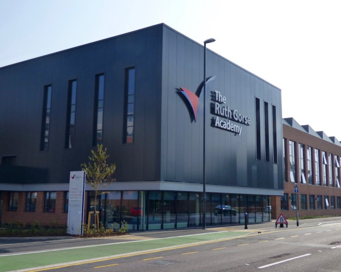 Modern school building with sign reading 'The Ruth Gorse Academy'.
