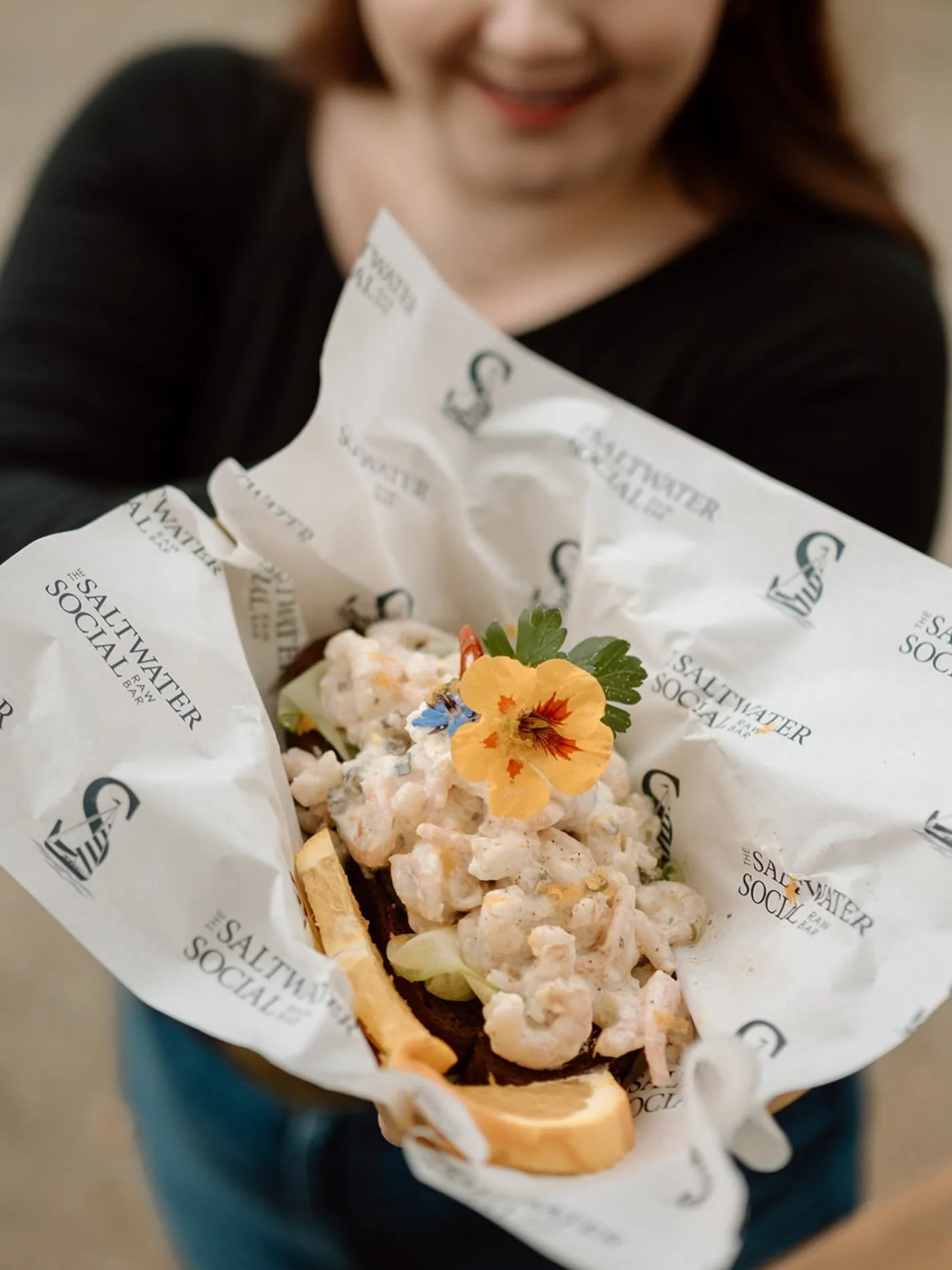 A Saltwater Social favourite. Tender North Atlantic shrimp tossed in our house made dressing with fresh herbs, crisp and bright citrus notes, served open-faced on toasted artisan bread. Finished with seasonal garnishes and edible flowers for a dish t