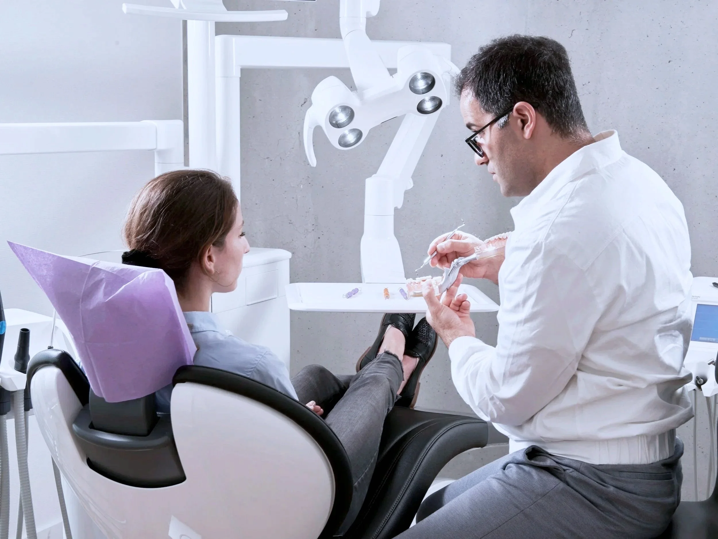 Dentist examining a patient's mouth in a dental clinic.