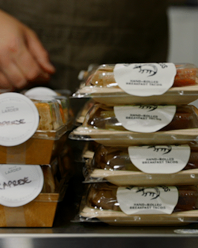 Stacked containers of breakfast parfaits on a table.