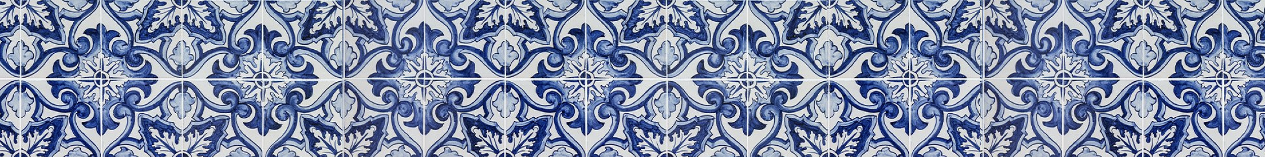 Close-up of decorative blue and white patterned tiles with floral and swirl designs.