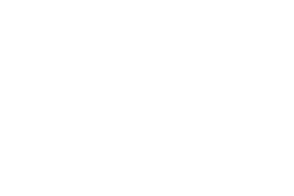 Close-up of a vintage-style GE logo with cursive text inside a circle on a black background