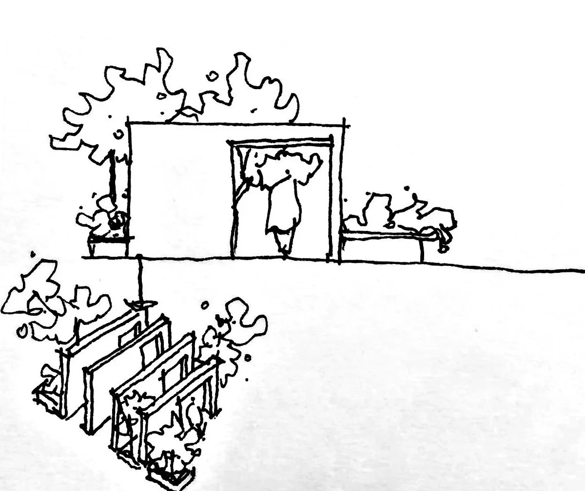 Line drawing of a person standing on a stage or platform under a canopy, with trees and benches nearby, and three framed pictures leaning against the platform.