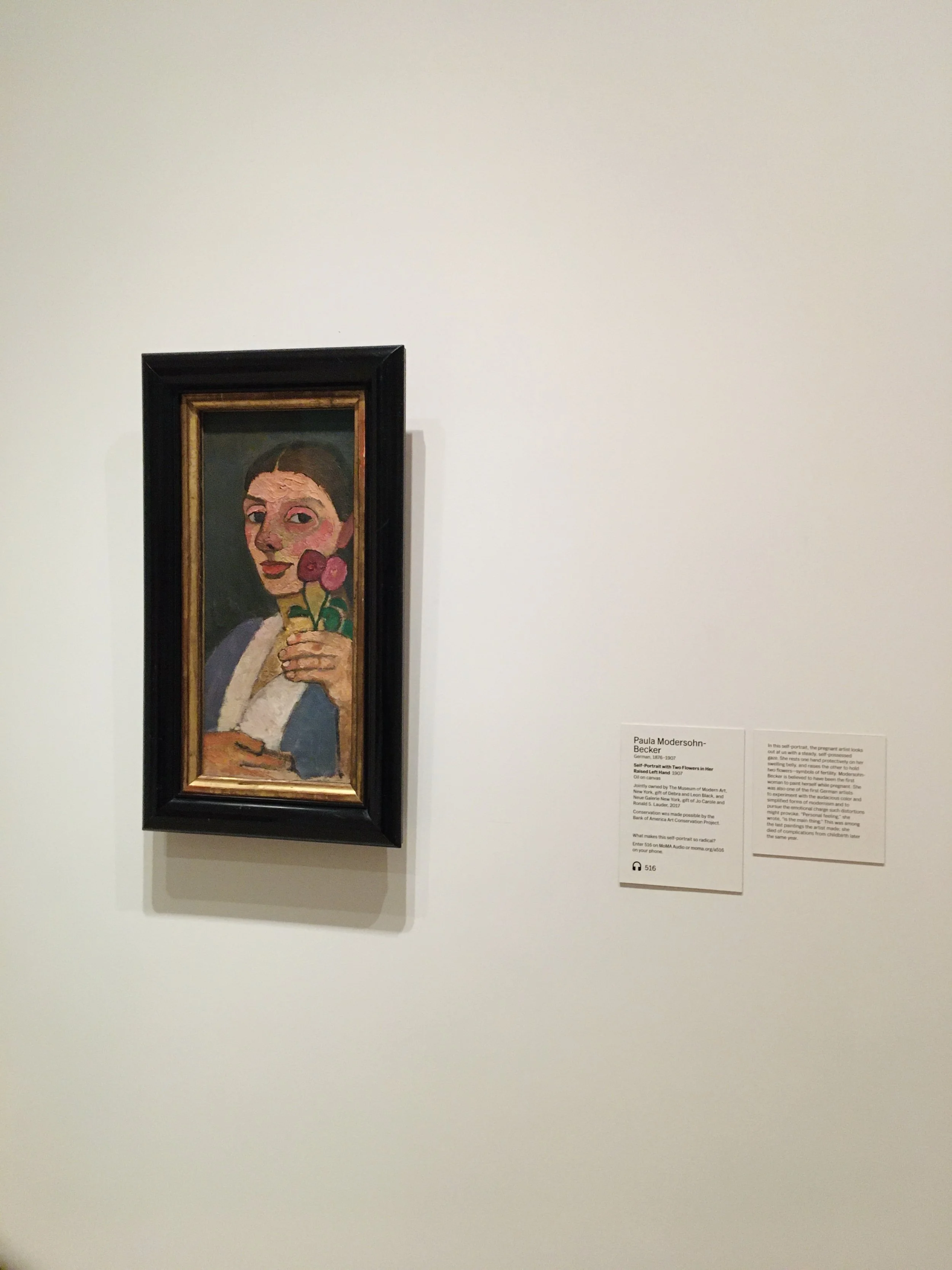A portrait of a woman holding a flower, painted in a modern, abstract style, displayed on a museum wall.