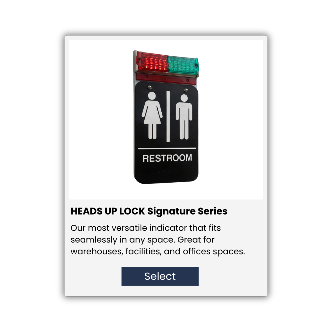 A restroom indicator sign with black background, featuring white icons of a female and male, separated by a vertical line, with a red and green emergency light on top, and a description below about the HEADS UP LOCK Signature Series indicator.