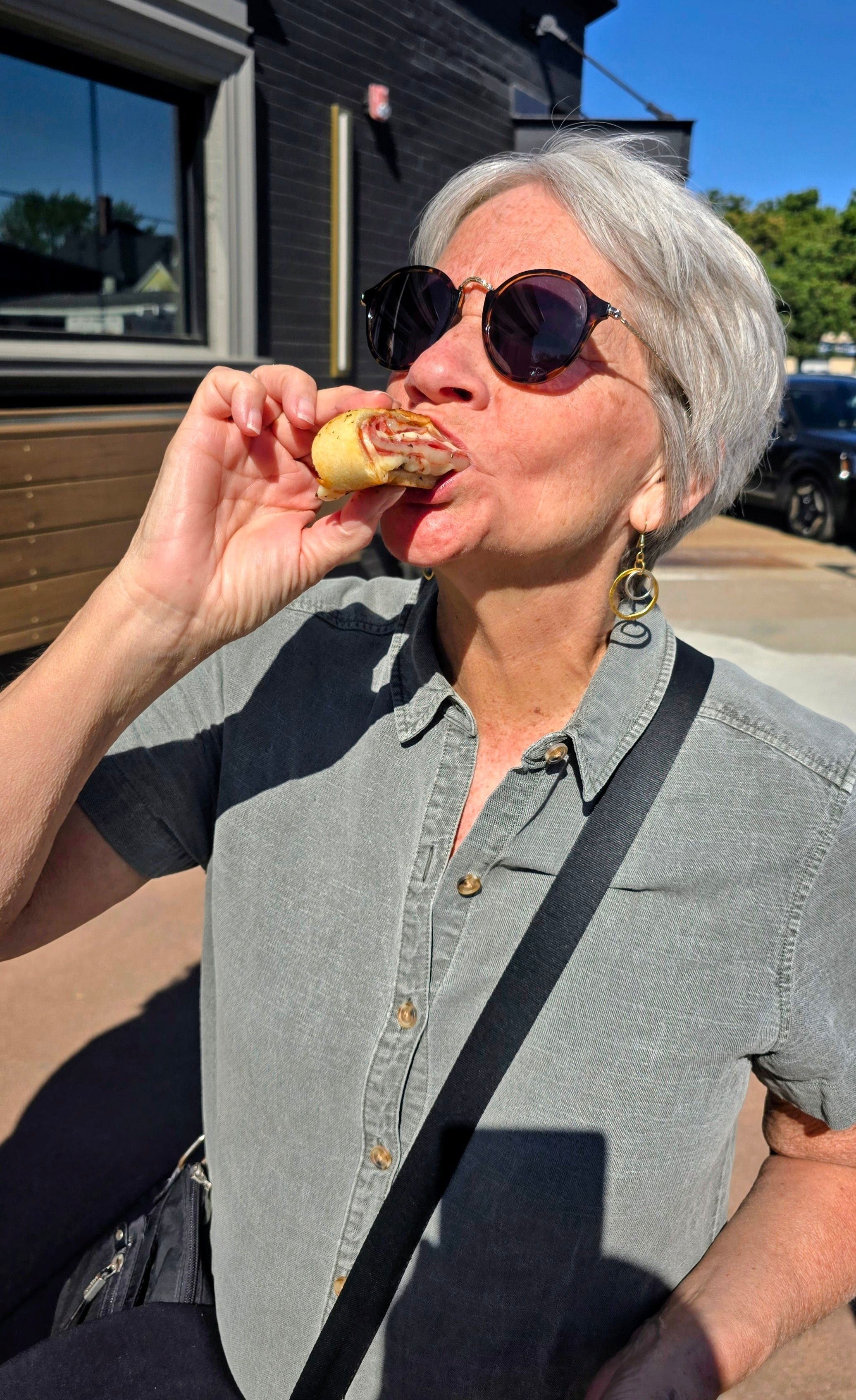 Woman eating Stromboli on an MSP Food Tours food tour