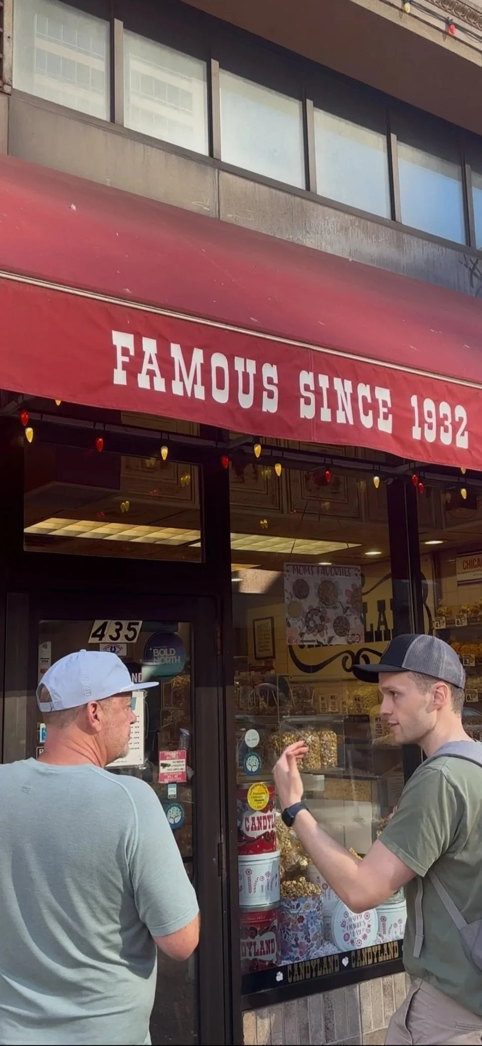 2 men in front of Candyland candy store in Saint Paul