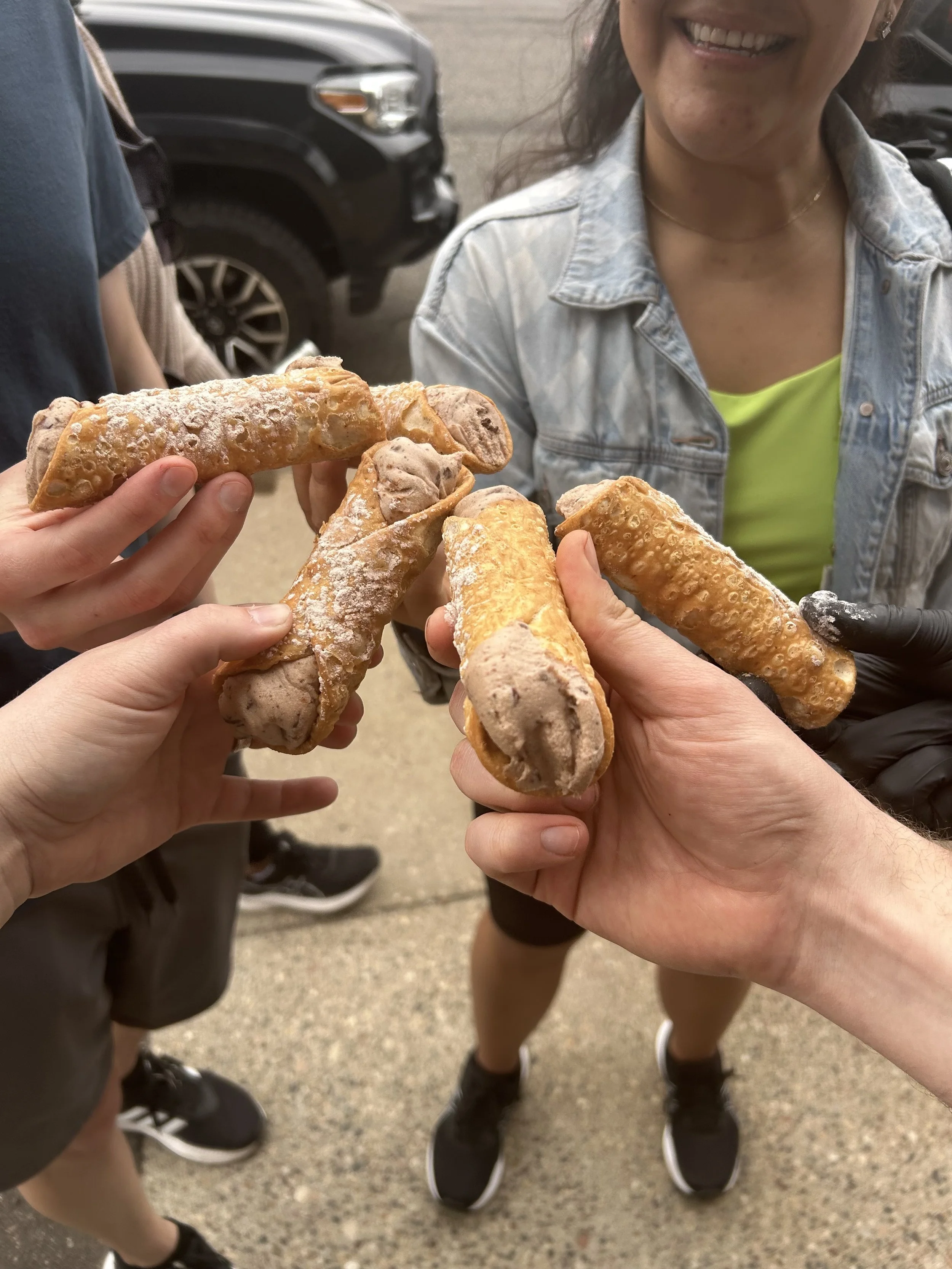 Group Holding Cannoli on St. Paul Signature Tour