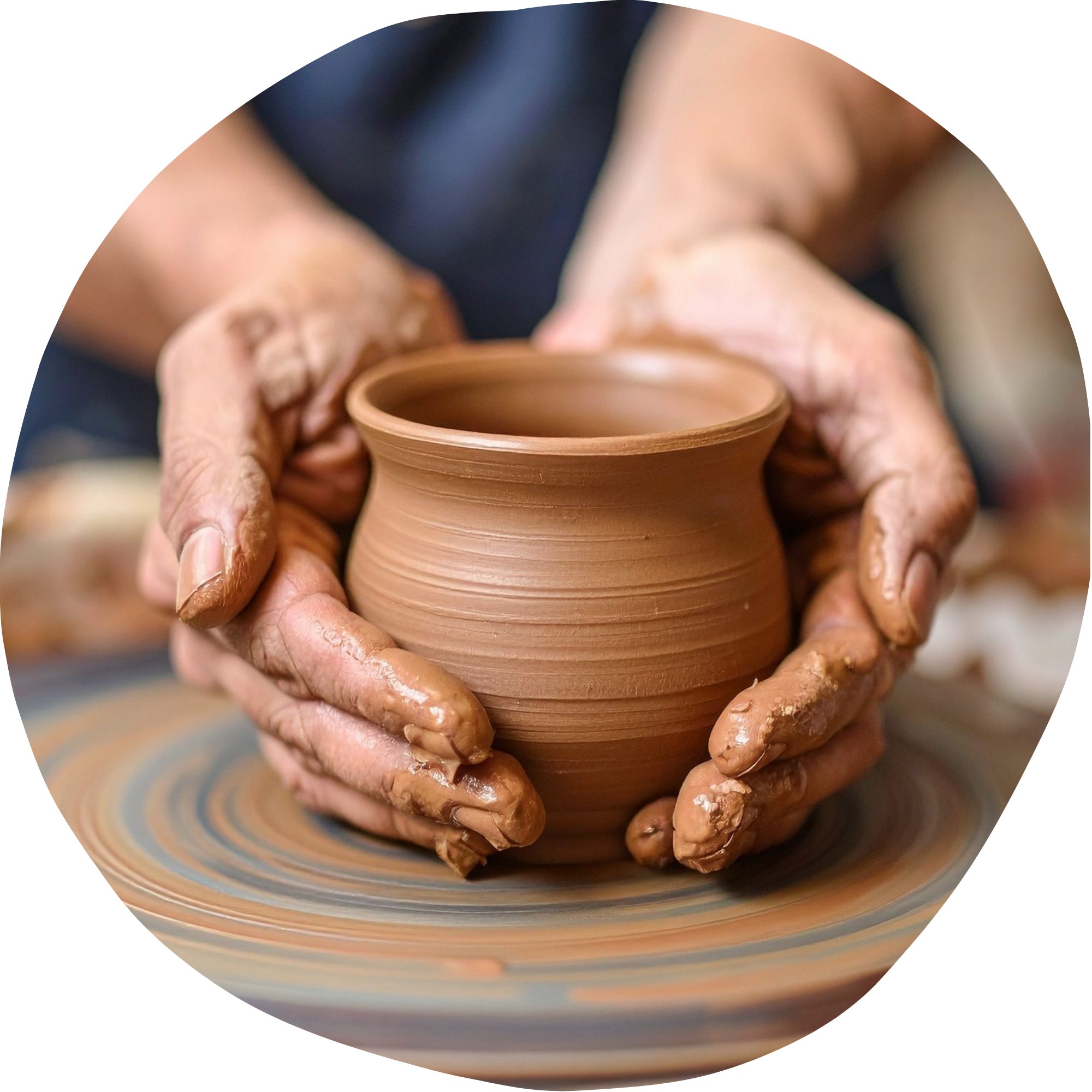 Hands shaping a small clay vesscle on a pottery wheel during the ceramics process.