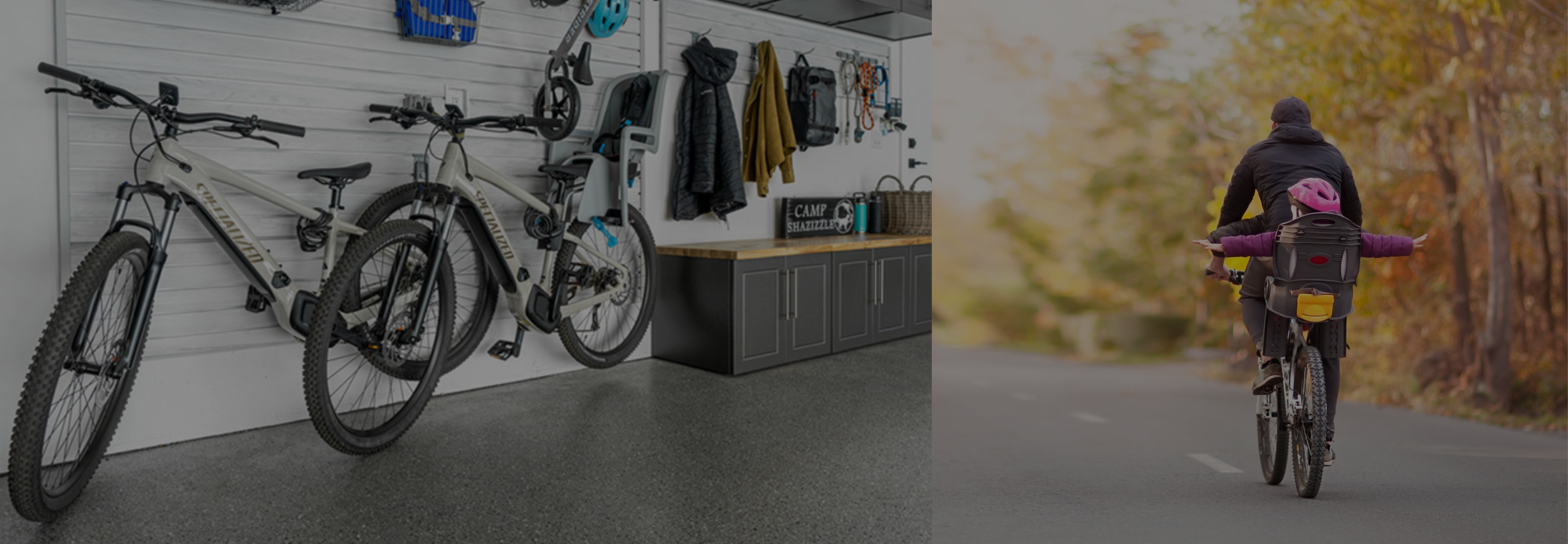 A garage with two stationary bicycles hanging on a wall and outdoor scene of a parent and child riding bikes on a tree-lined road in autumn.