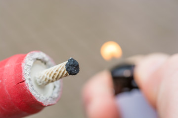 picture of someone lighting a firecracker