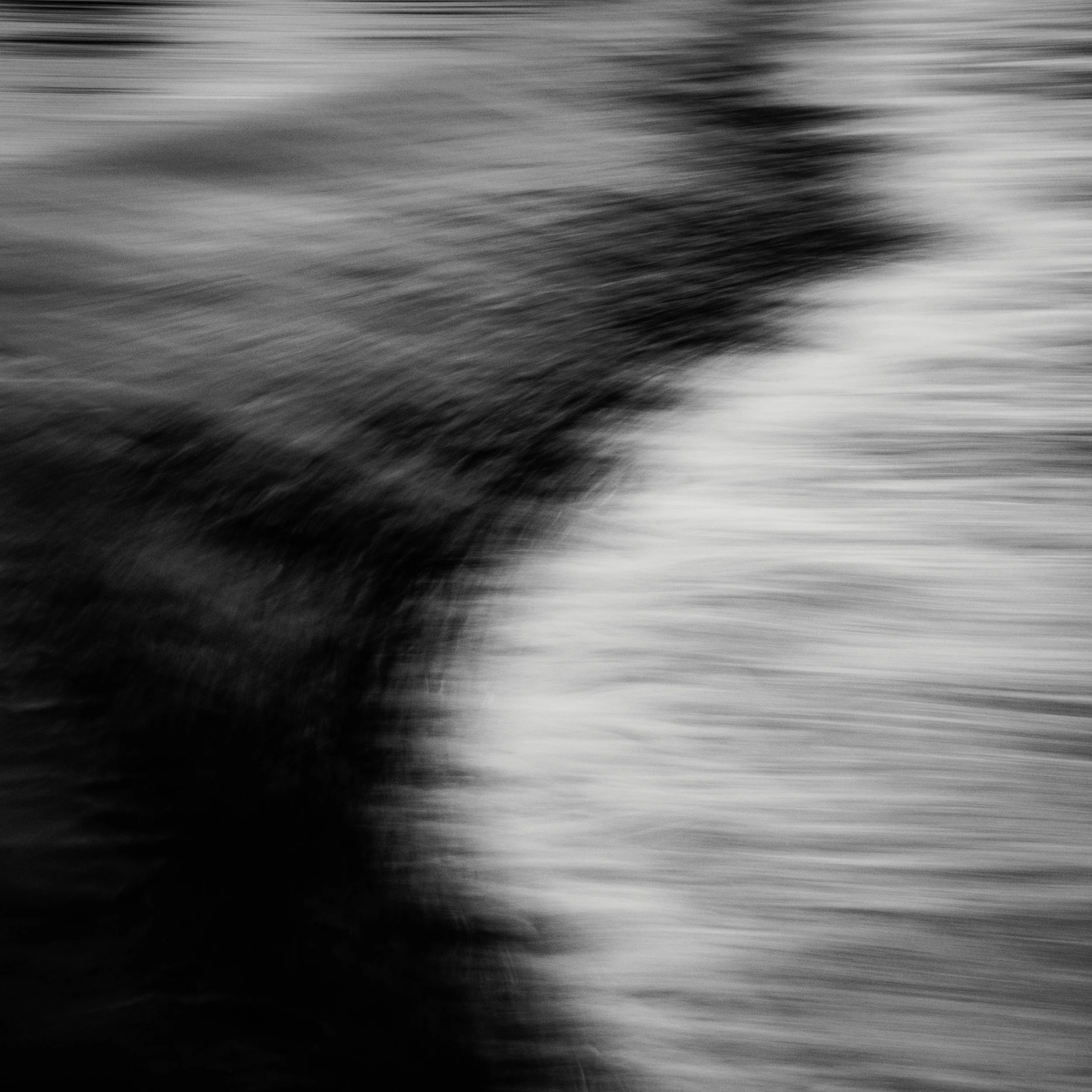 Abstract photography in black and white featuring extreme motion blur and dynamic contrast.