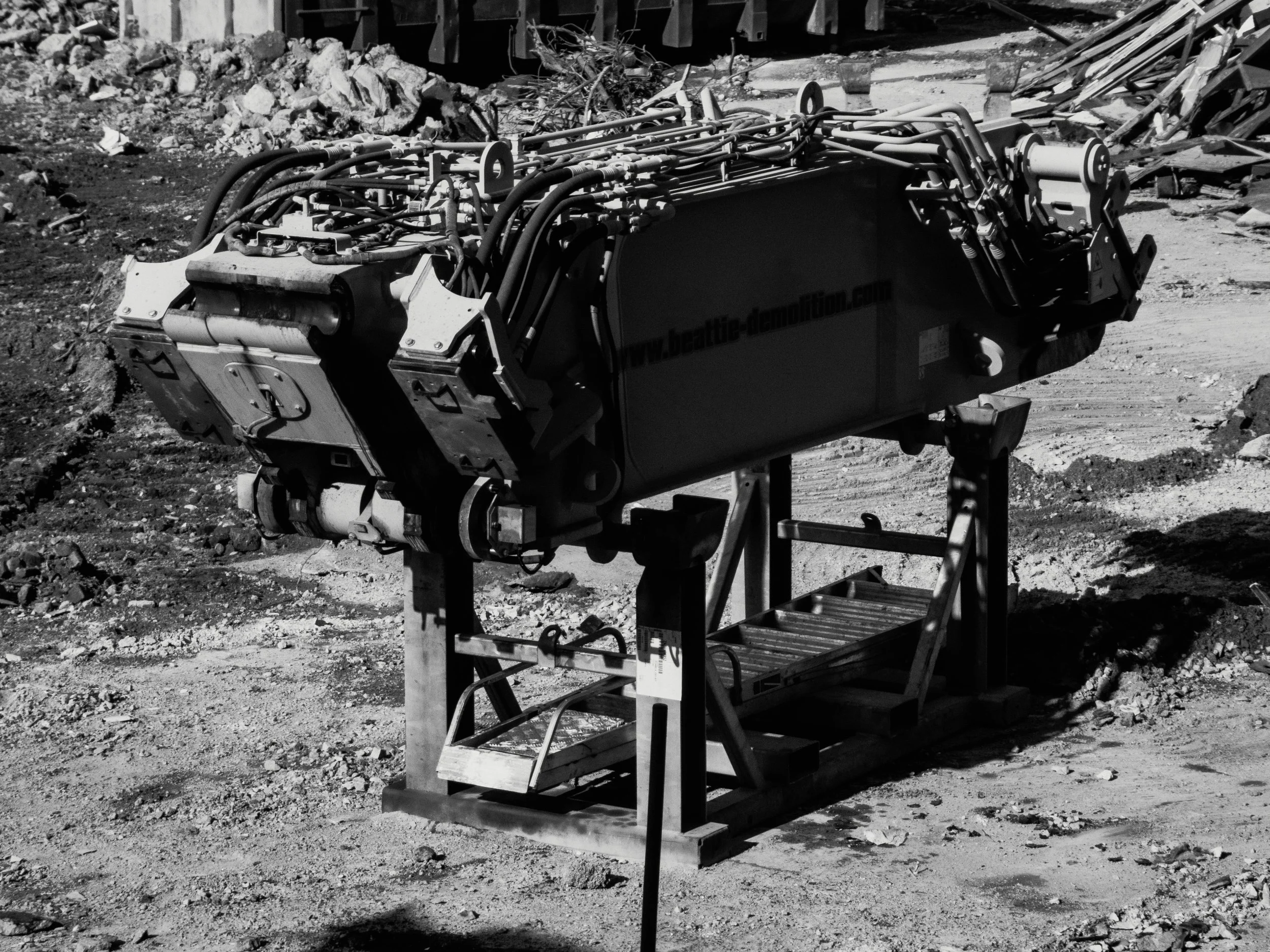Demolition attachments waiting on site frames between shifts.