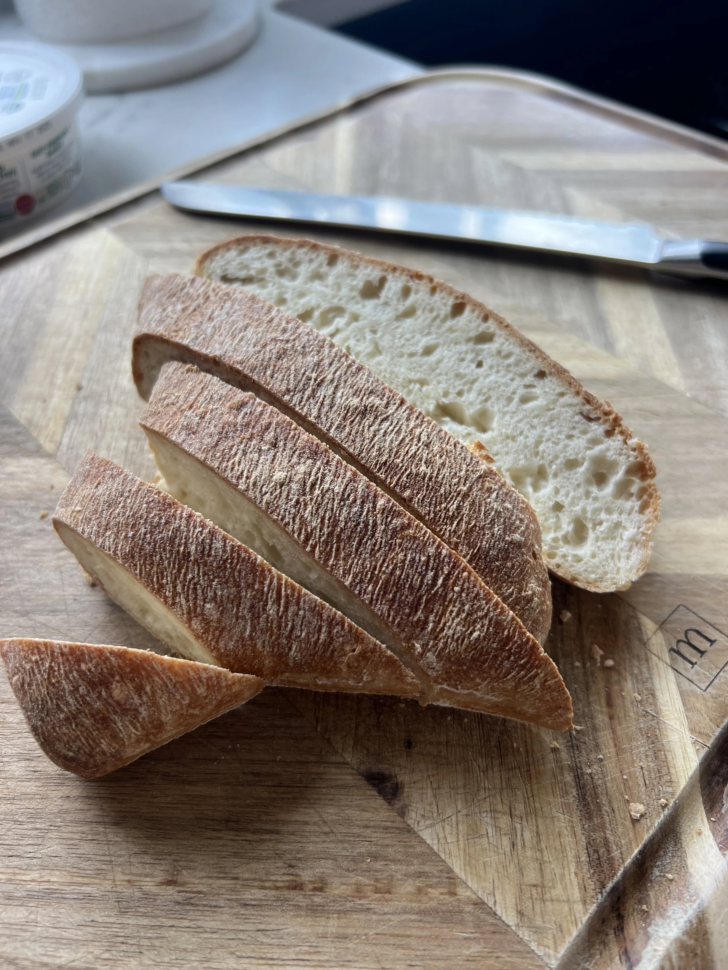 Warm Izzio ciabatta bread served alongside an Italian platter