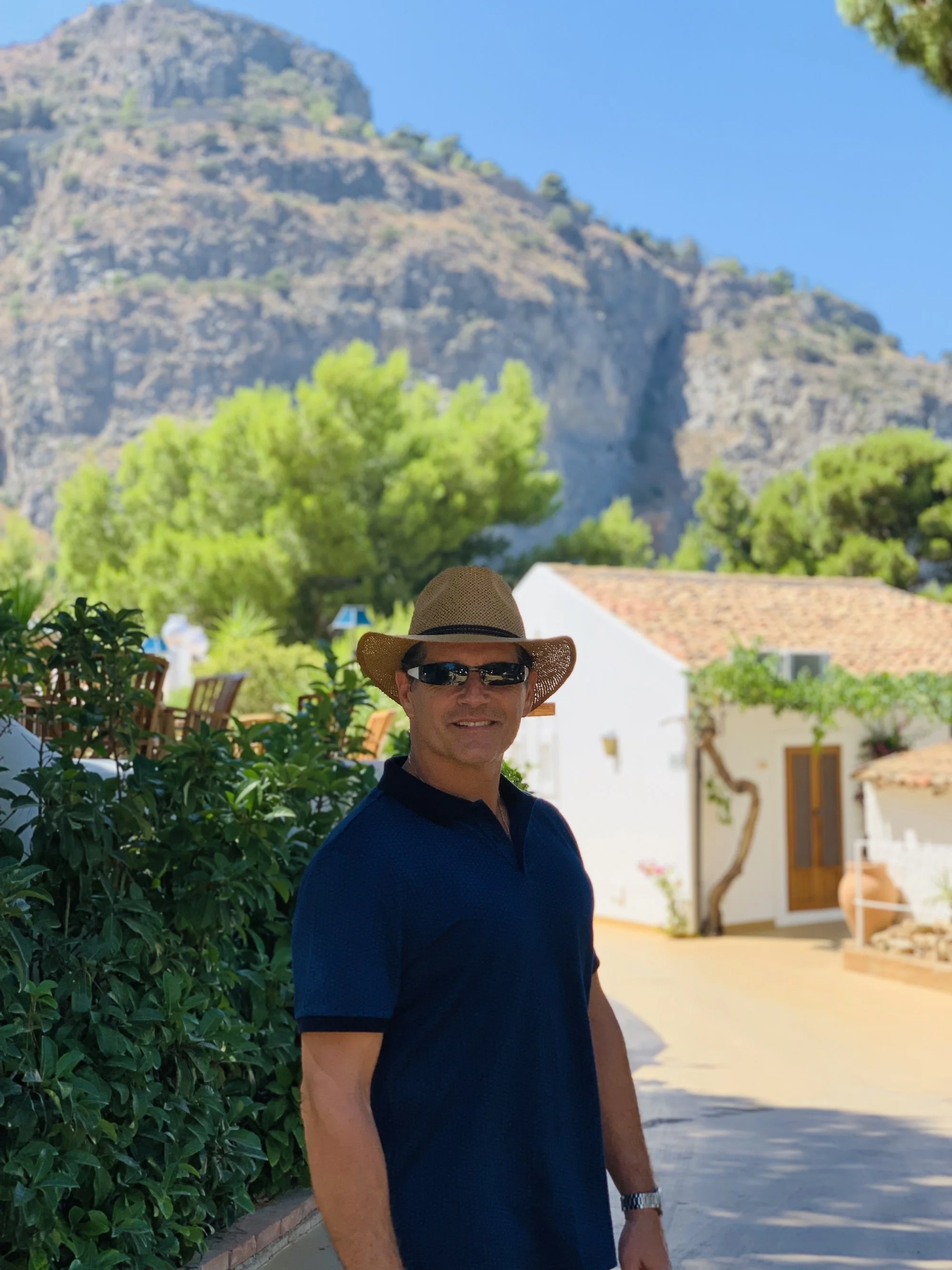 Ray Haiduk standing outdoors in a peaceful countryside setting, reflecting a grounded, faith-based approach to wellness and life.