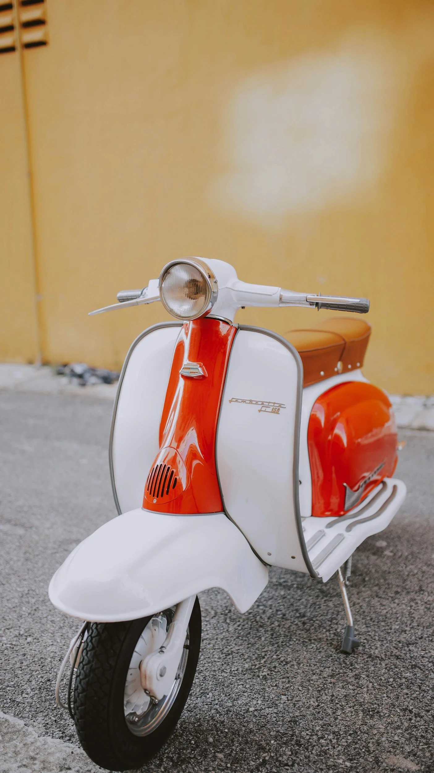 Vintage Italian scooter parked on a quiet street, representing living the sweet life with joy, freedom, and intention.