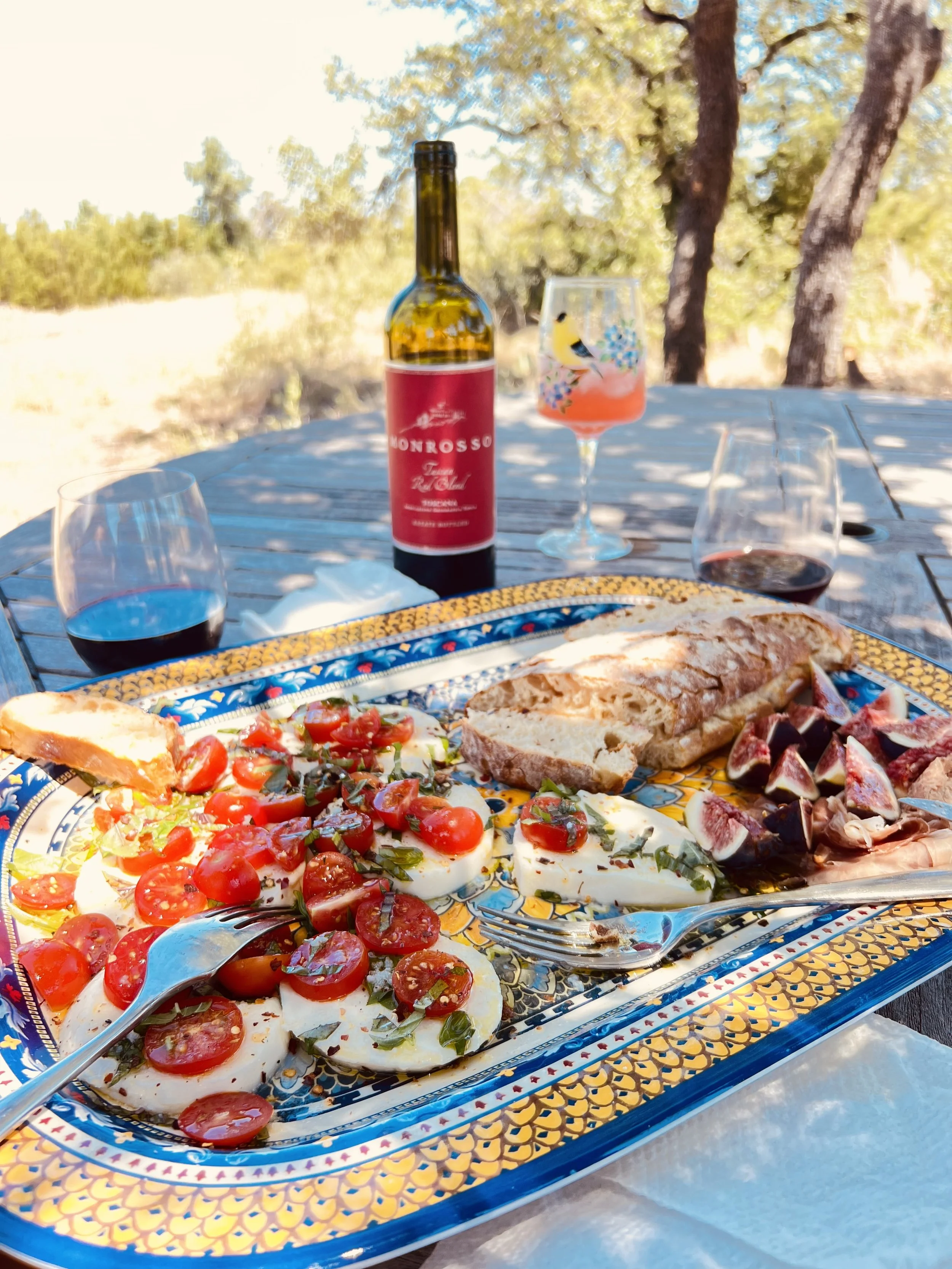 Italian caprese platter with figs, prosciutto, tomatoes, and buffalo mozzarella on the Farmopathy hilltop