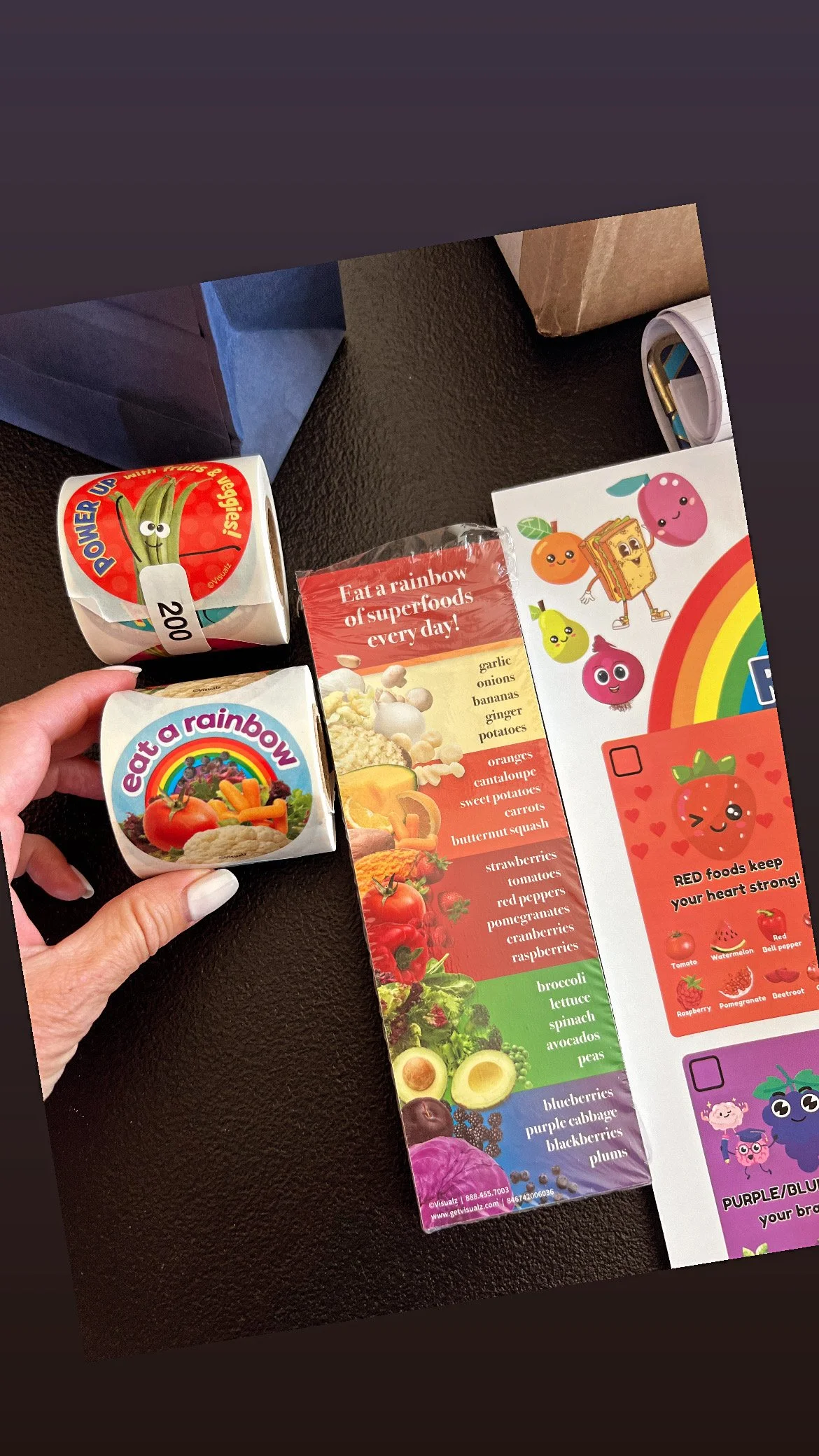 Colorful educational food pamphlet featuring cartoon vegetables and fruits, with two small cartons labeled "Eat a Rainbow" and a guide listing various vegetables, fruits, and berries.