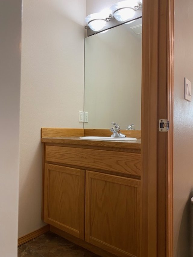 Alternative angle of the original bathroom layout before the modern renovation. A Kitsap County home before-and-after comparison highlighting the shift to a bright and functional design.