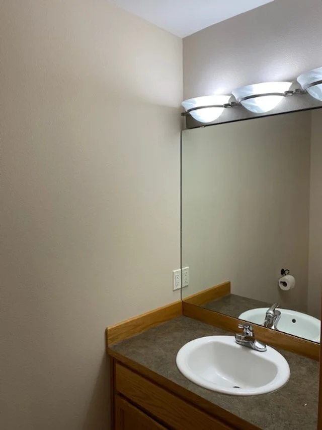 Original outdated powder bathroom in Kitsap County before an intentional design-build transformation. This 'before' view shows the space prior to the Daybreak Design & Build modern refresh.