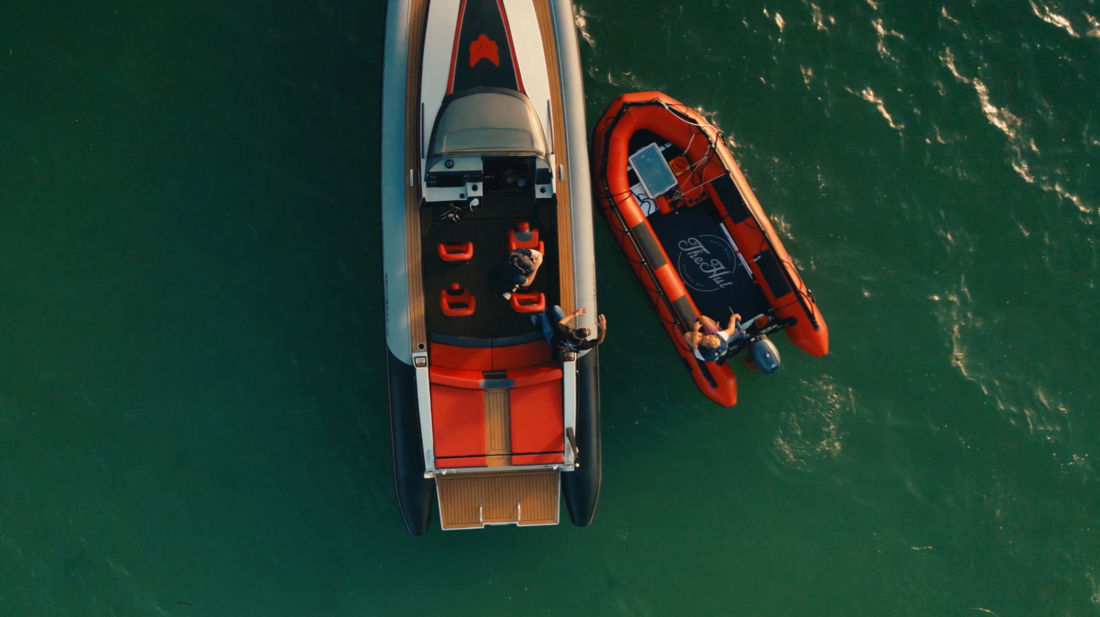 Aerial view of Attitude Charter guests arriving by powerboat to The Hut’s tender in Colwell Bay.
