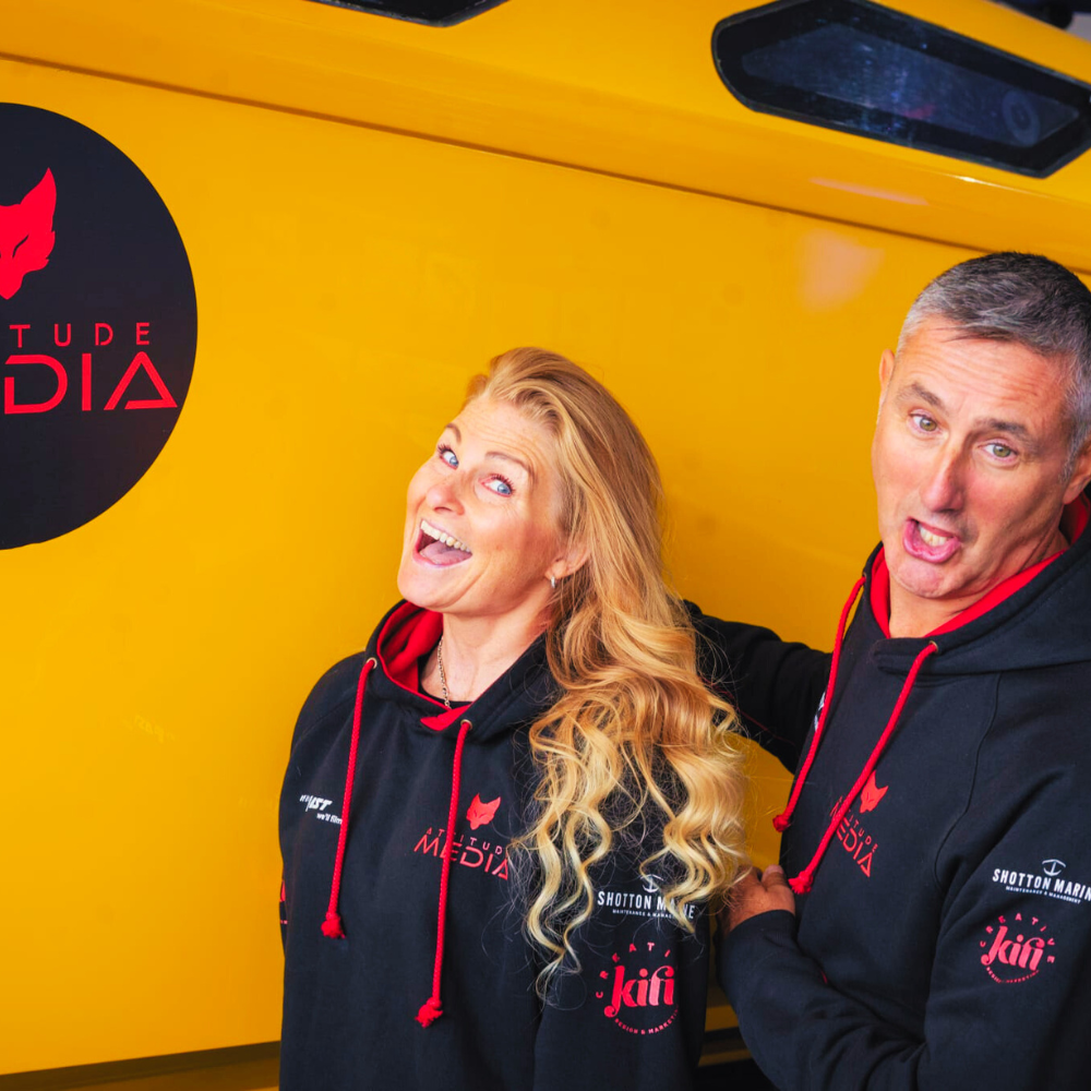 tim coe and terri spencer of attitude media at southampton boat show 2025 in front of fountain 42 falcon multispark winner of the 2024 cowes torquay uk offshore powerboat race with an attitude media logo on the boat