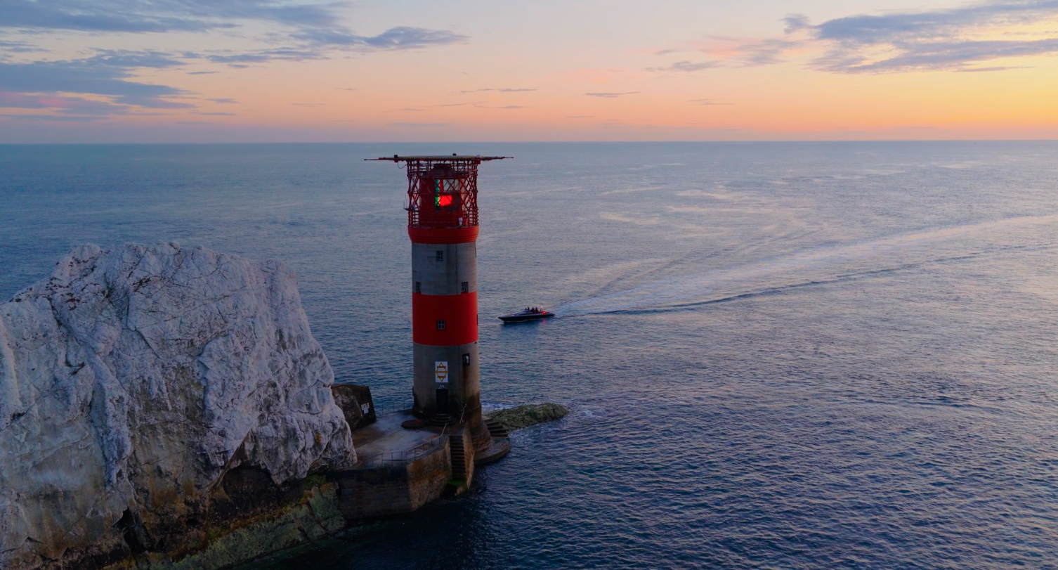 attitude charter rib up close at the vneedles lighthouse at sunset