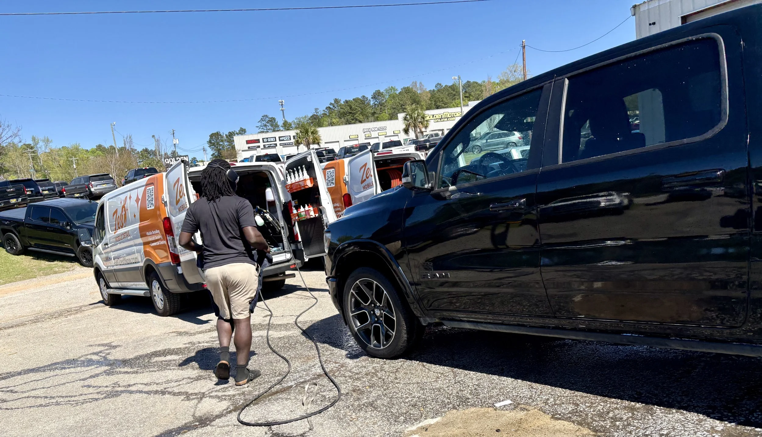 A Zest Mobile Detail technician performing a professional mobile detail on a Ram truck at Golden Motors in Columbia, SC. Our fully equipped mobile detailing units bring premium interior and exterior detailing services directly to dealerships, busines