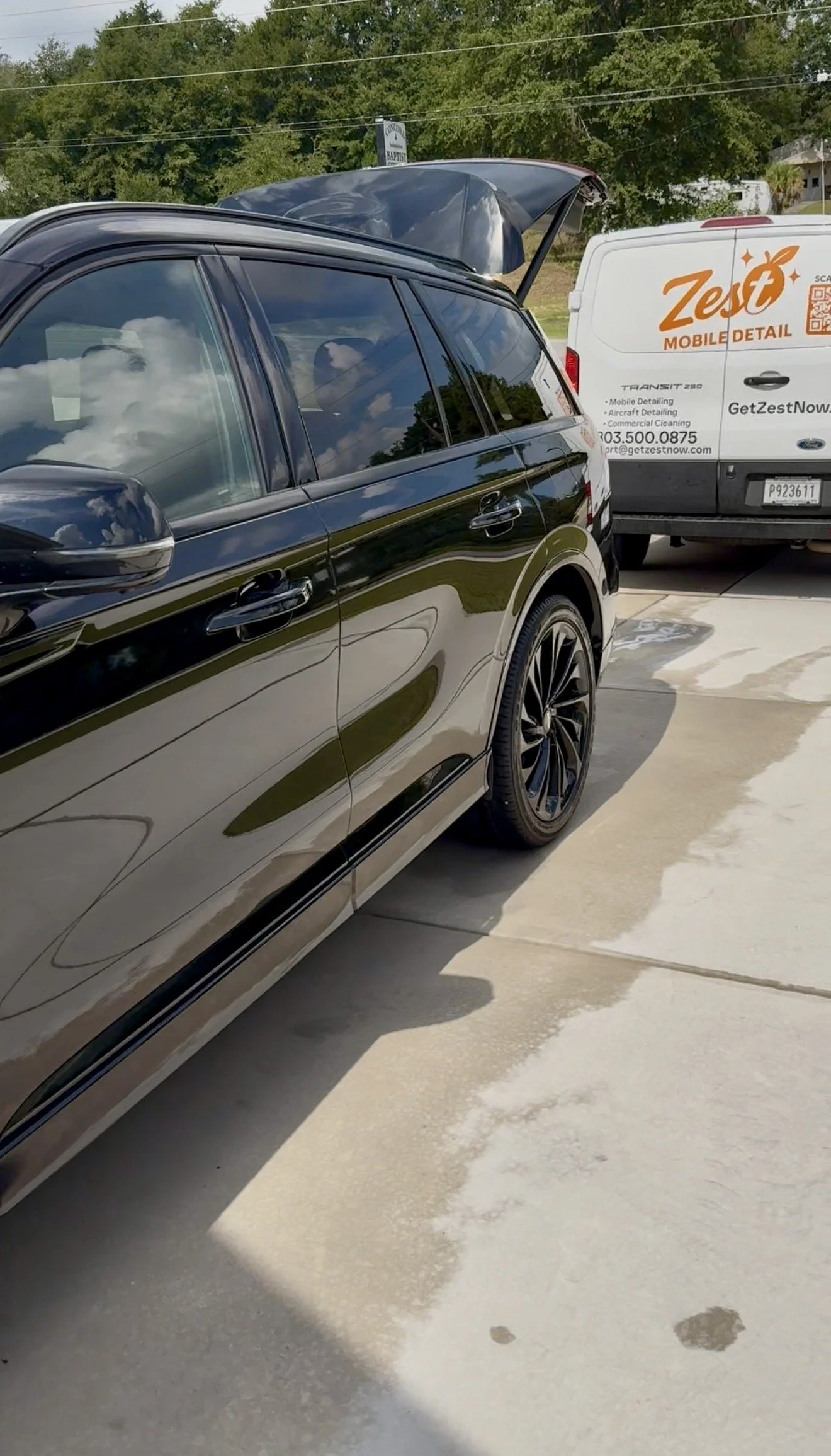 Zest Mobile Detail van parked behind a Lincoln Aviator being detailed and polished in a driveway in Lexington, SC